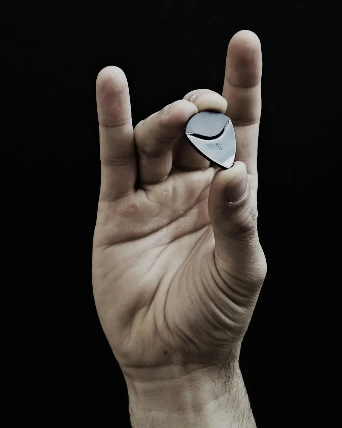 Acoustic guitarist playing with fingers and a guitar pick
