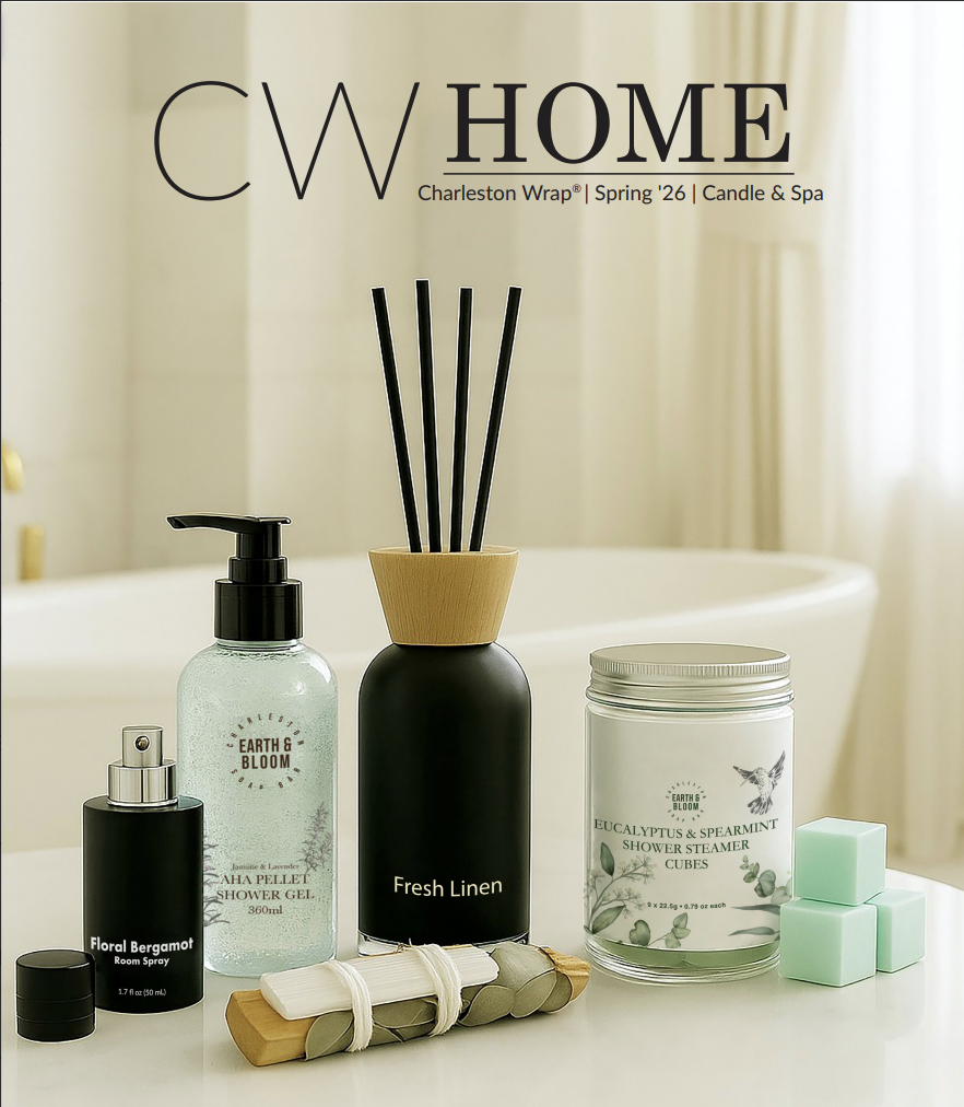 Bathroom countertop with shower gel, reed diffuser, room spray, shower steamer cubes, and soap, with a bathtub in the background.