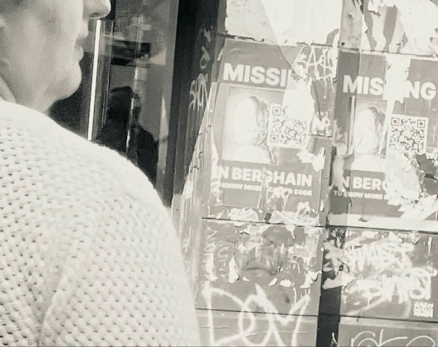 Graffiti an einer Wand mit verschiedenen Postern, die Texte wie 'MISSION' und 'N BERCHAIN' zeigen, sowie eine Person, die im 1. Plan im Halprofil steht. Photographic Collage, Black and White experimental photography in Berlin.