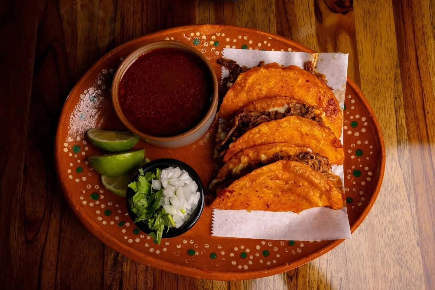 Quesabirria tacos with melted cheese and dipping broth Geneva IL Mexican restaurant