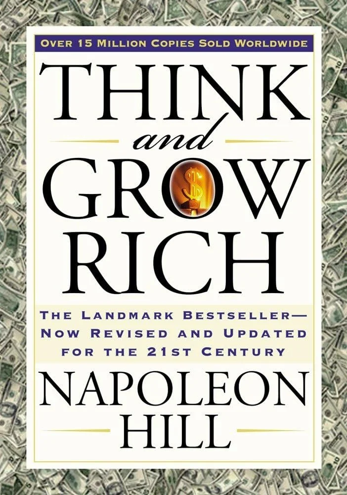 Book cover of "Think and Grow Rich" by Napoleon Hill, with a background of dollar bills. The title has a gold money symbol in place of the letter 'O' in 'Grow'.