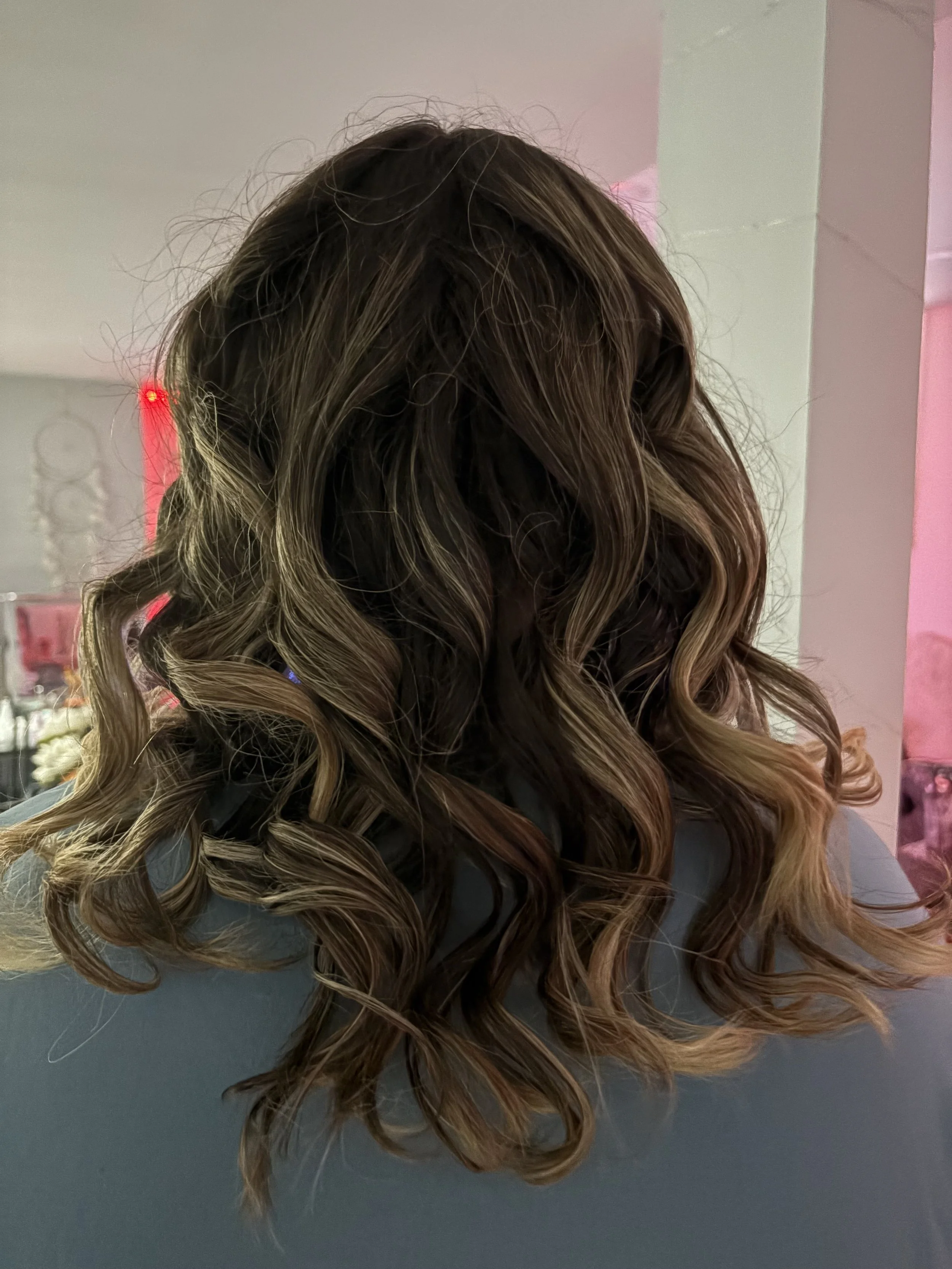 Wavy brown hair with blonde highlights, viewed from the back.