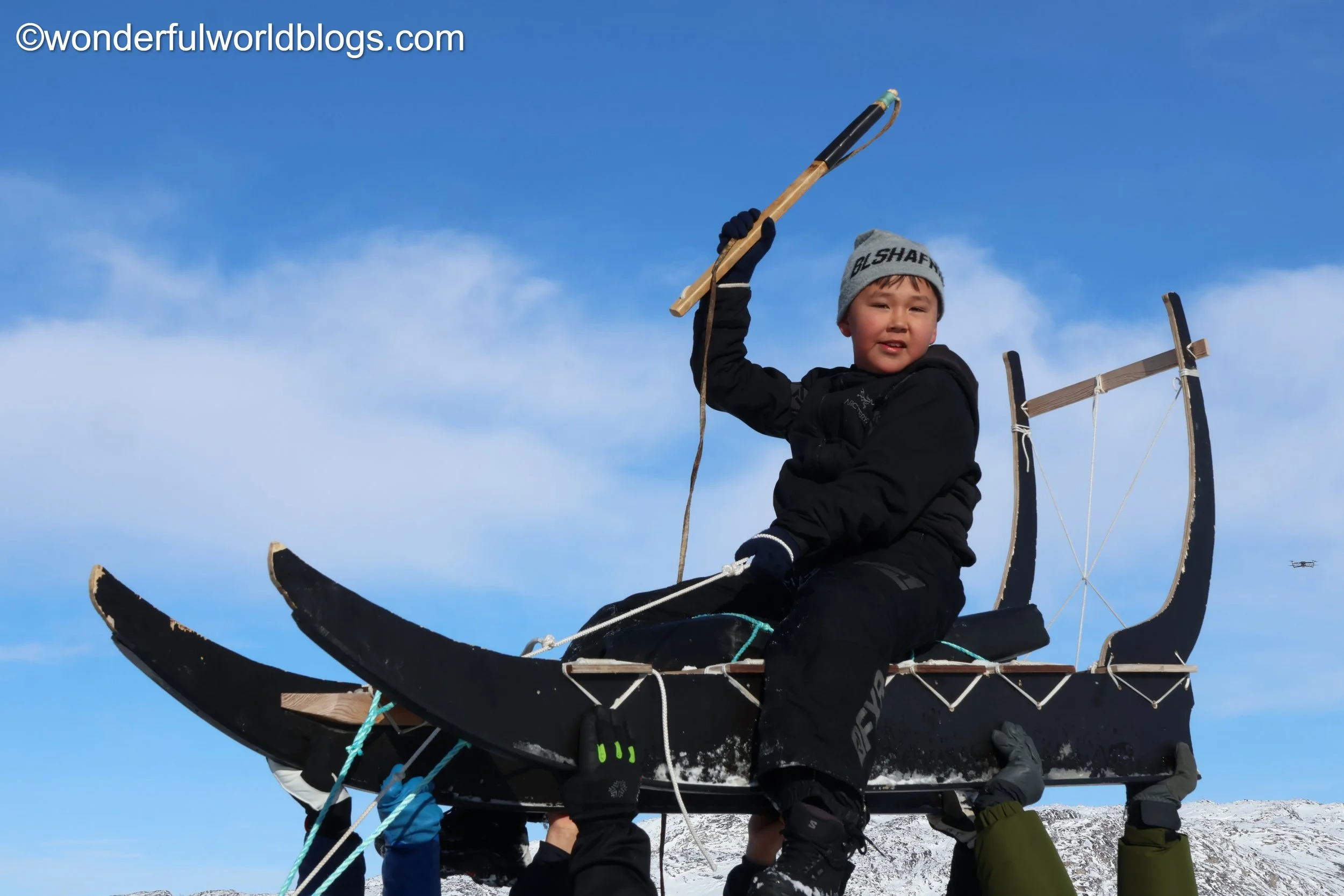 Boy on deg sled in Ilulissat Greenland
