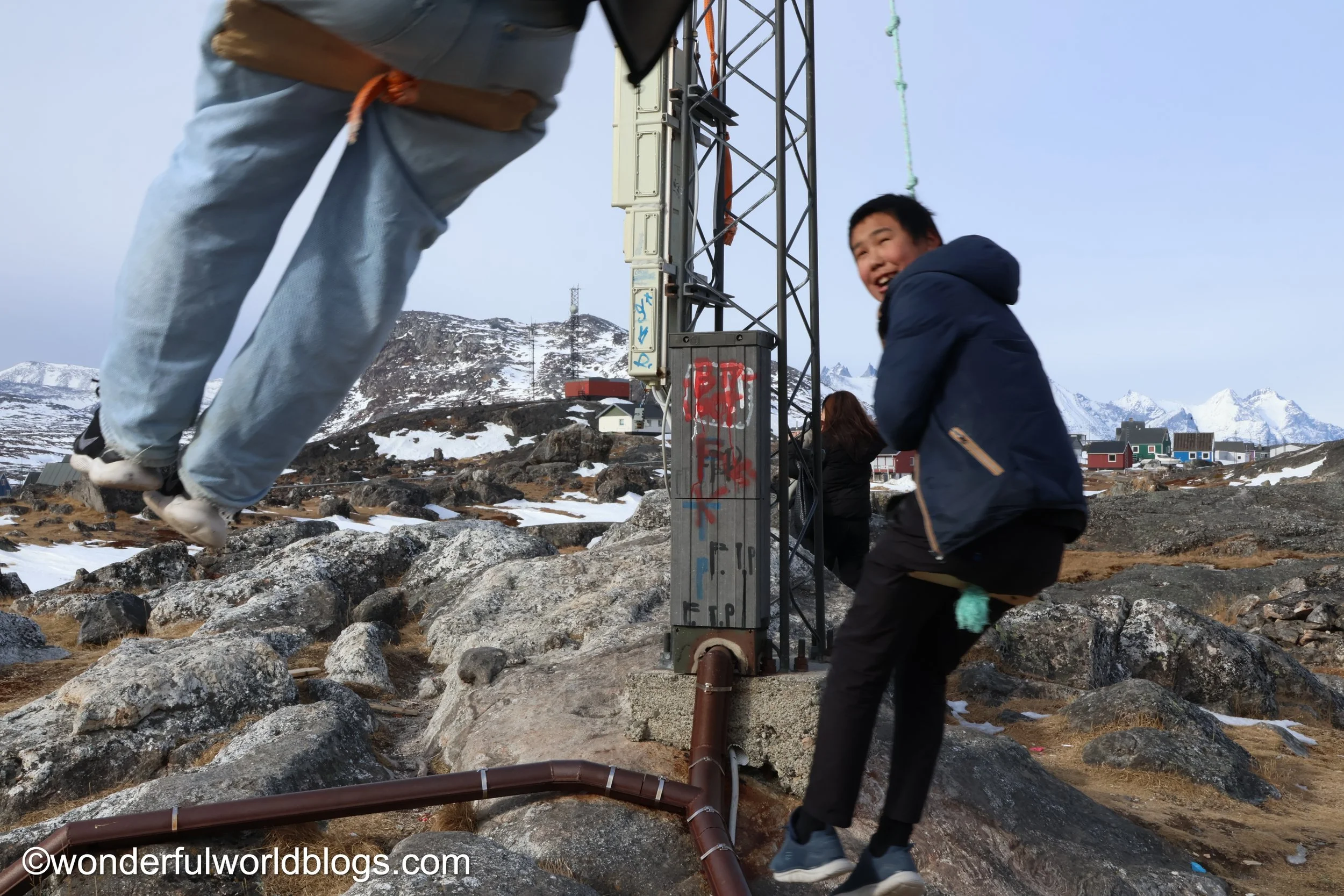 Boys on swing Nanortalik Greenland