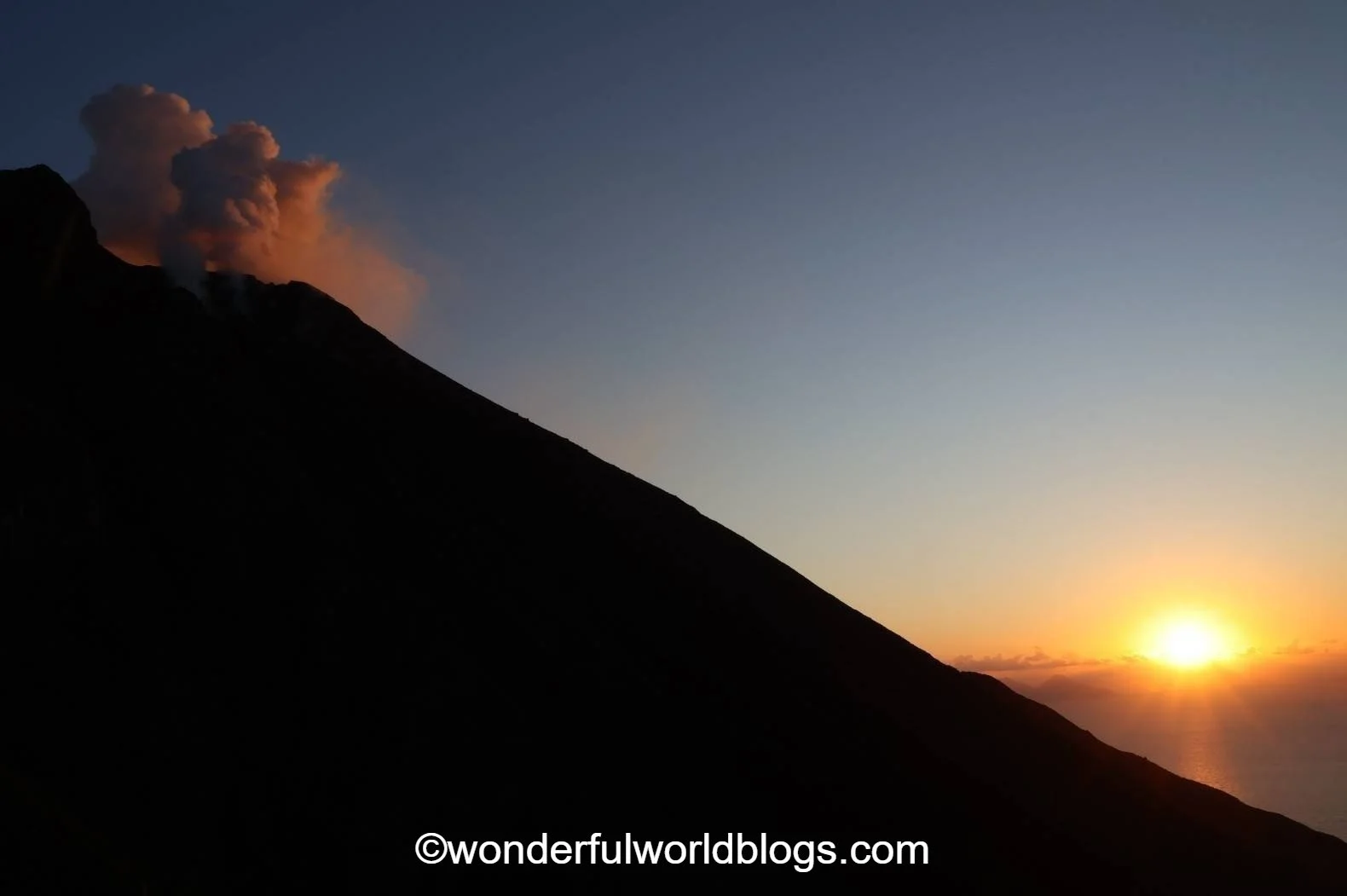 Stromboli volcano erupting at sunset Sicily Italy
