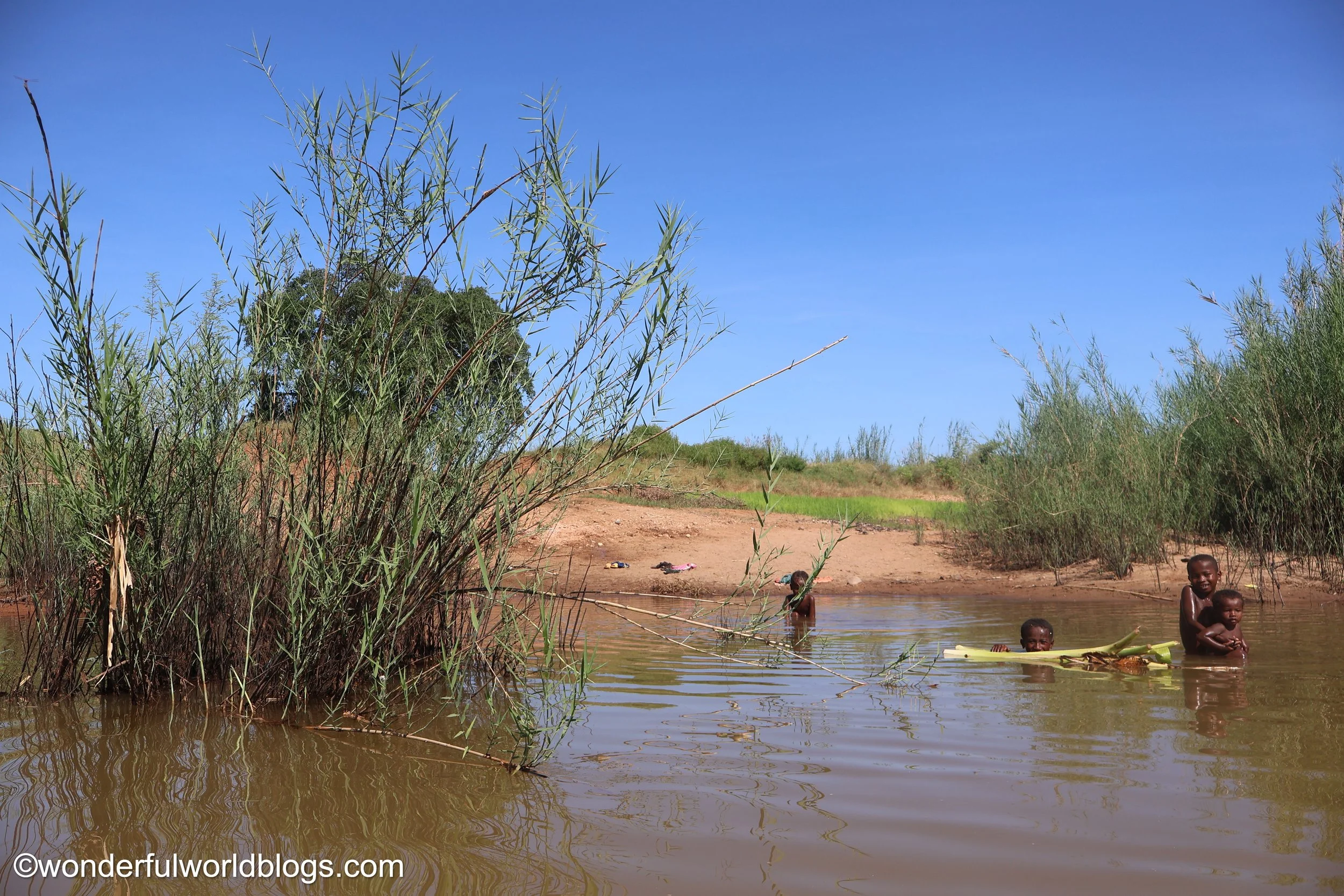 Water people bathing in Tsiribihina River in Madagascar