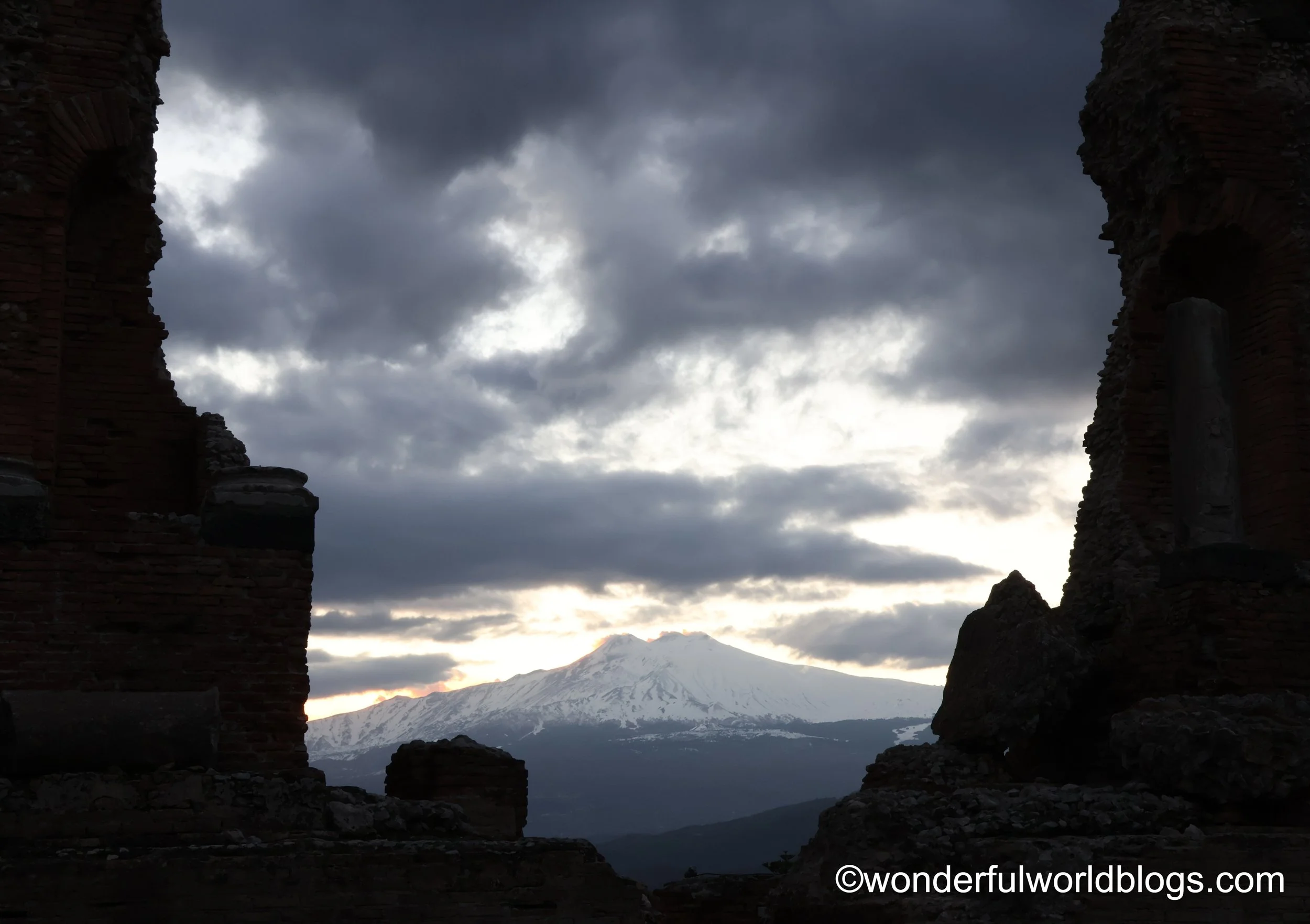 View from Taormina Roman theatre to Mount Etna at sunset Sicily Italy