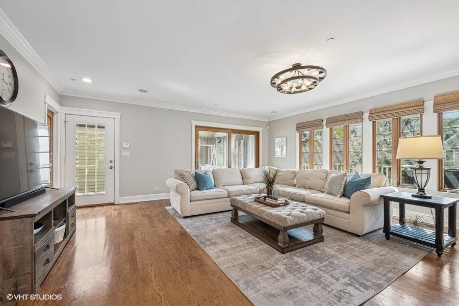 Close-up of a staged family room seating area with a focus on neutral textiles and coordinated decorative pillows.