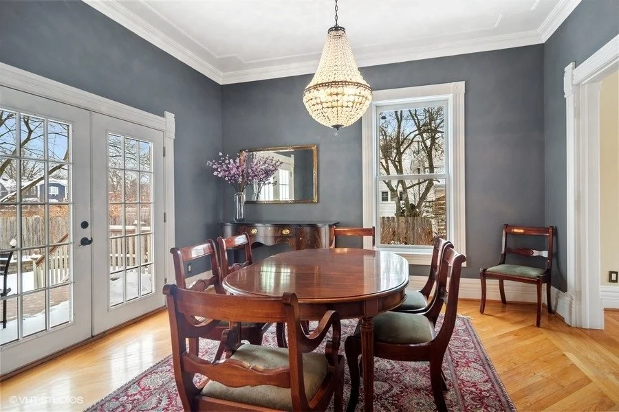 A contemporary living room staged with low-profile furniture and a soft, patterned rug.
