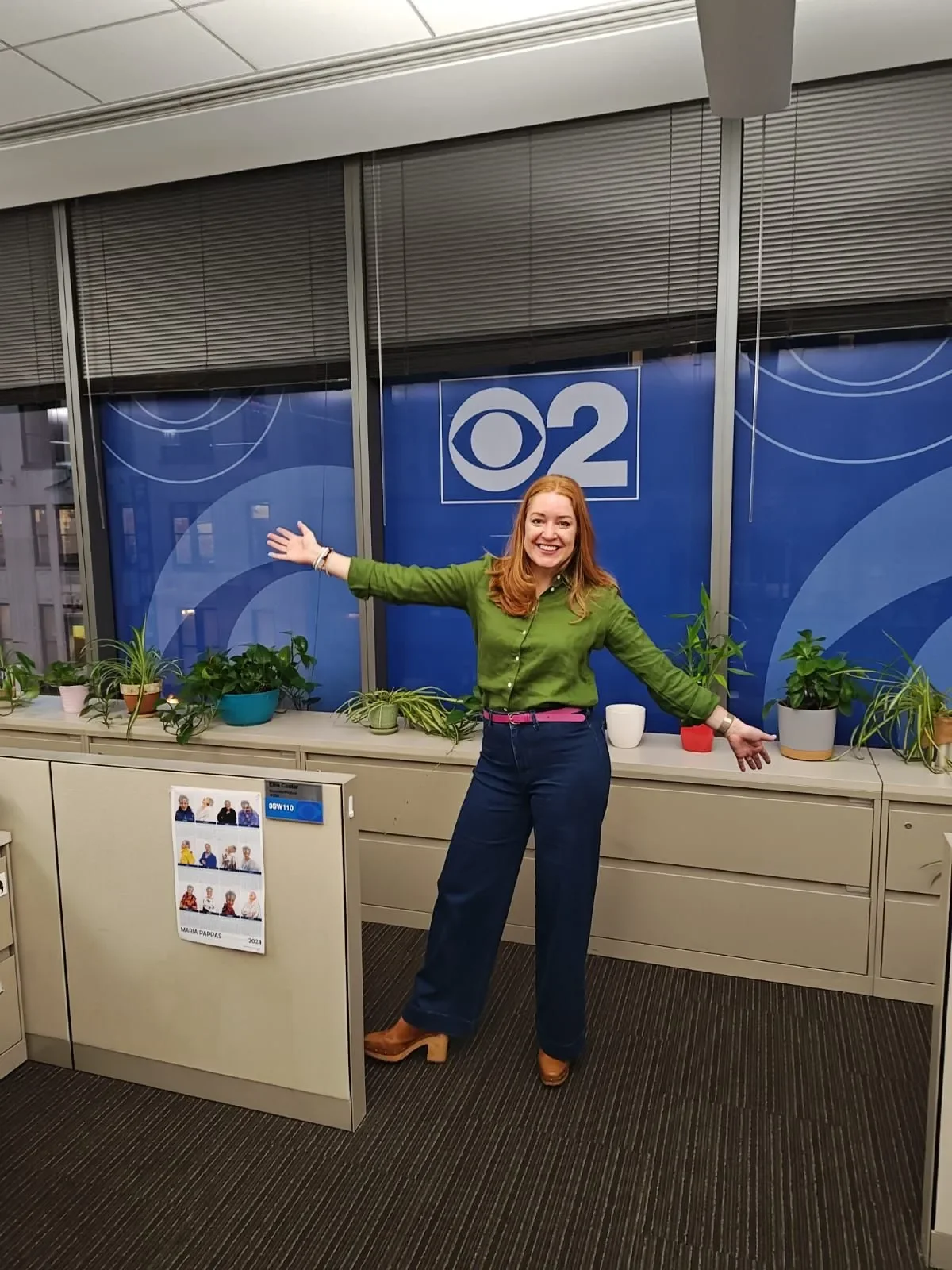 Ashley at CBS Chicago desk for an organizing segment. She is wearing a green blouse and dark jeans.