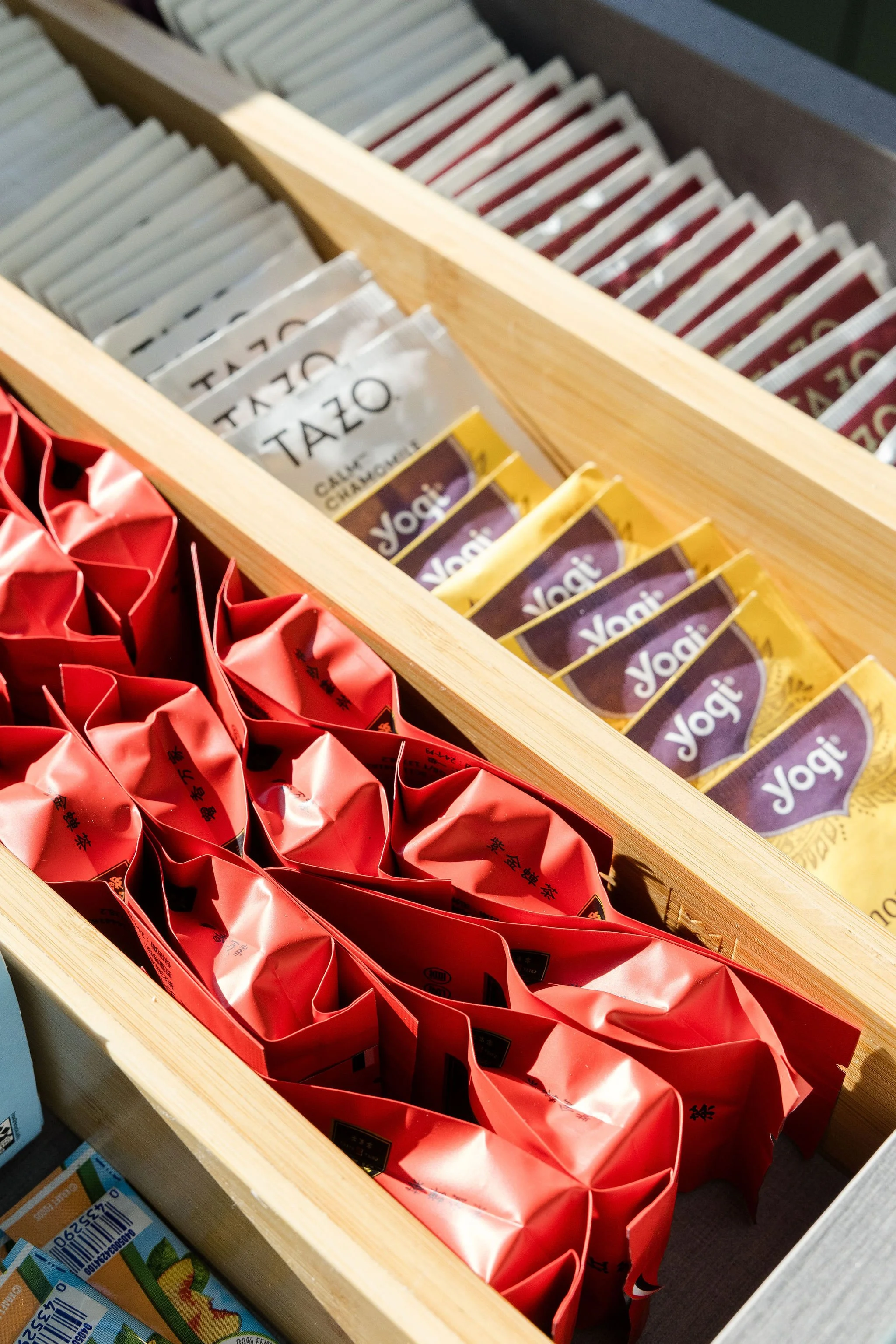 Well organized kitchen drawer with teas in rows based on flavor