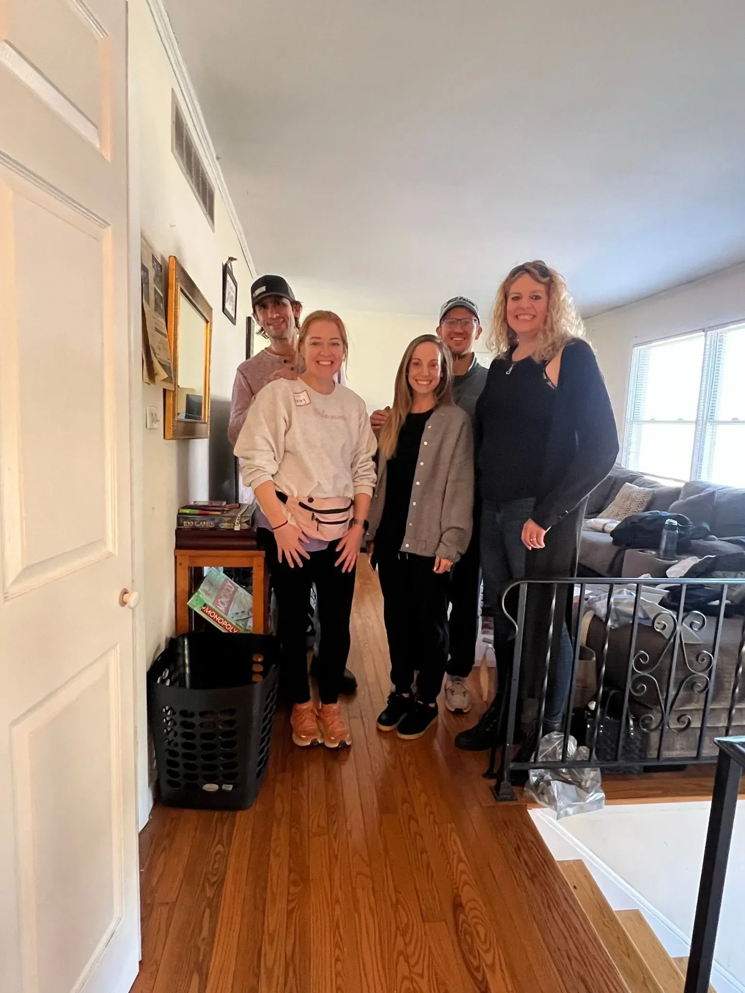 The HELLO! team posing in the living room before starting the give back day. Features three women and two men.