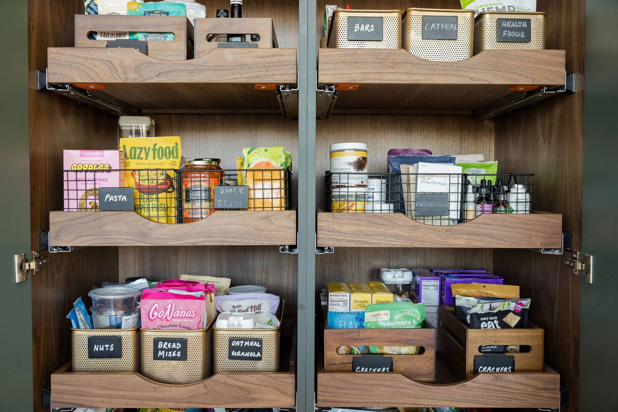 Well organized kitchen pantry with labels on the bin for each type of food