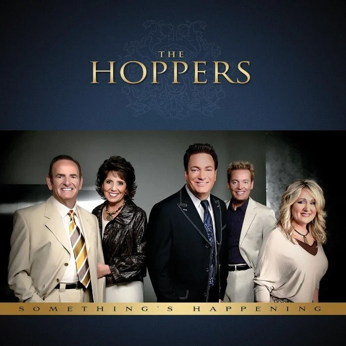 The promotional poster for the TV show 'The Hoppers' featuring five cast members standing together and smiling, with the show's title at the top and the tagline 'Something's Happening' at the bottom.