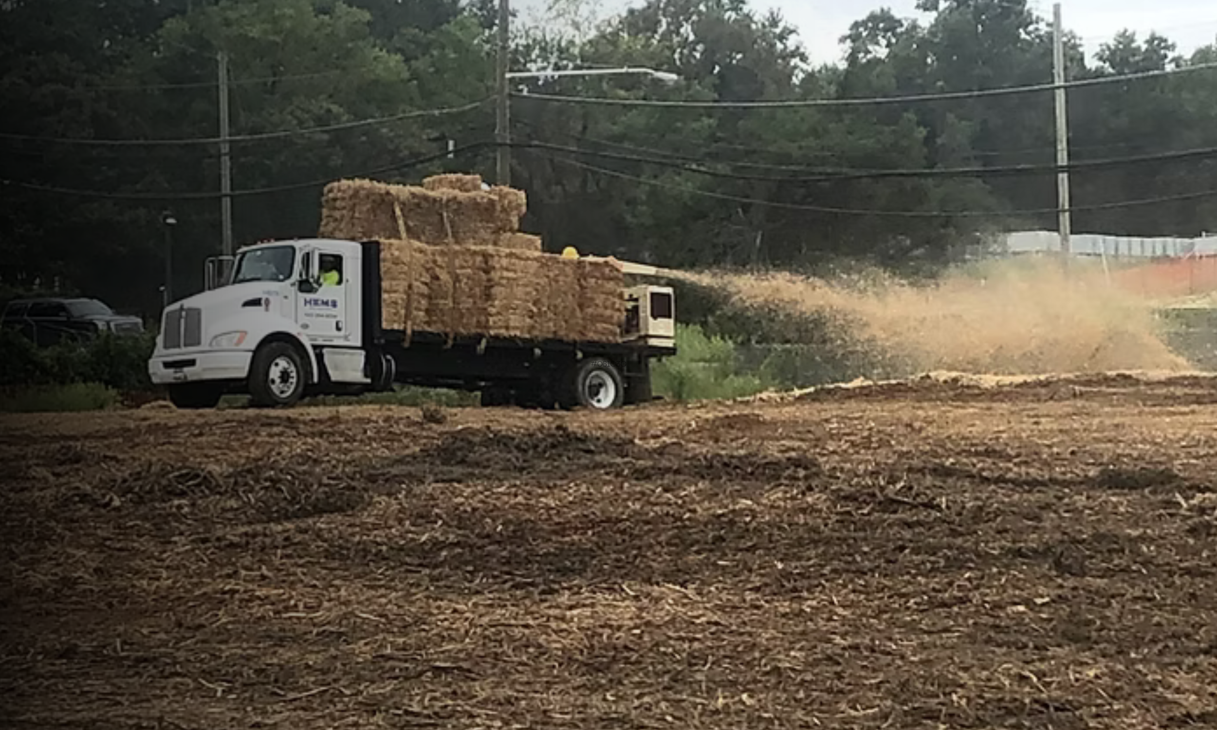 Straw blowing equipment applying ground cover for erosion and sediment control