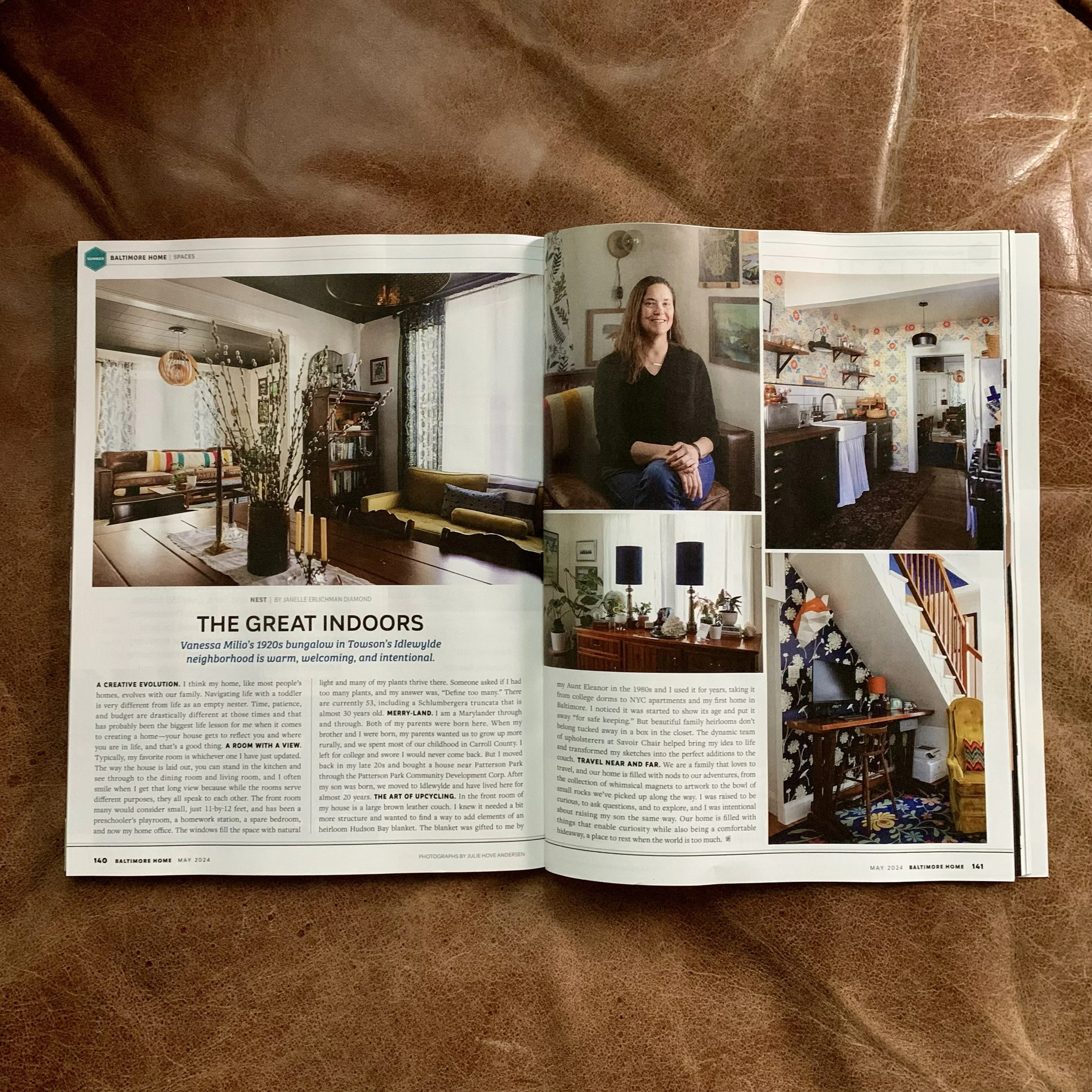 Open magazine featuring interior home design and a portrait of a woman, with various photos of a living room, kitchen, staircase, and decor.