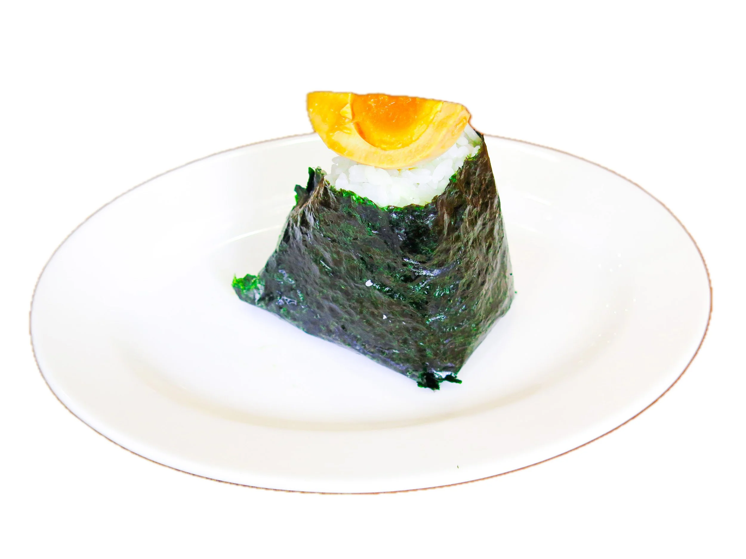 A piece of sushi wrapped in seaweed with rice, topped with a slice of orange-colored fish and placed on a white plate.