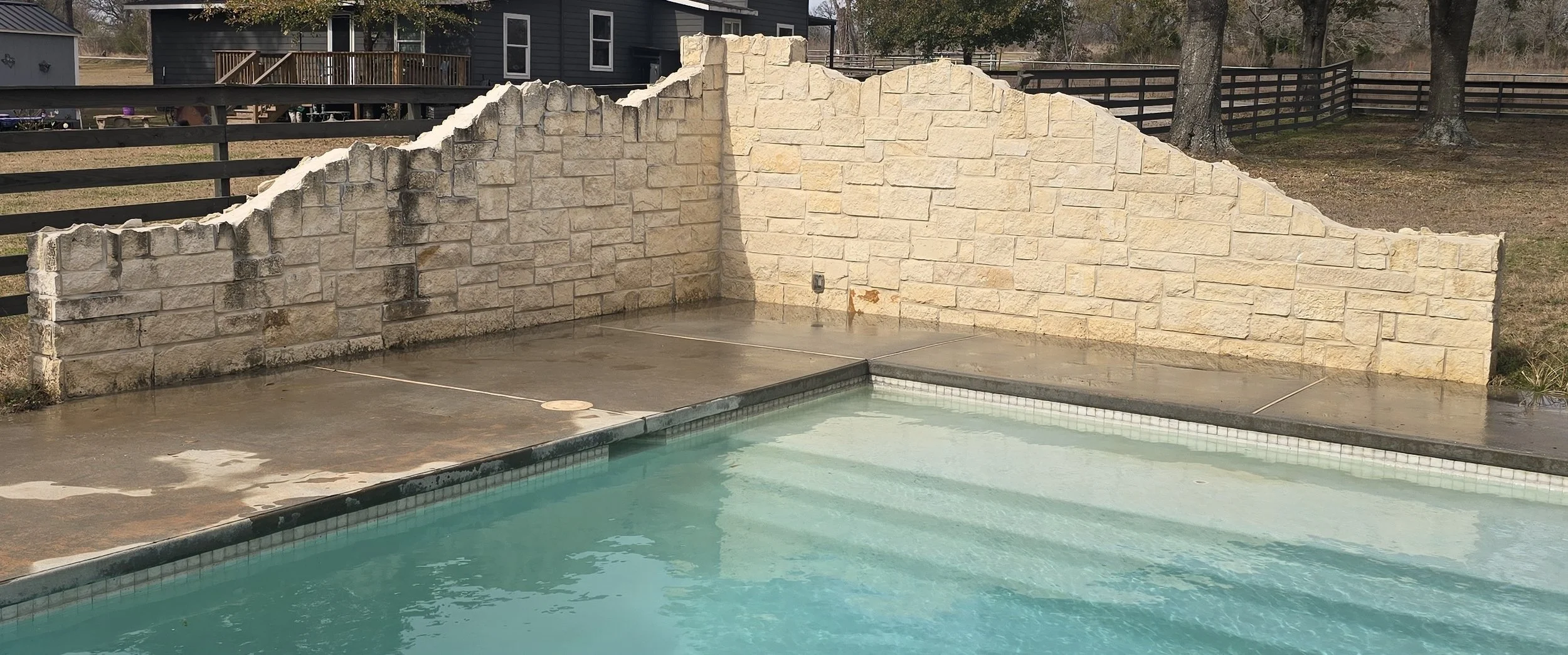 Limestone wall low pressure washed in Willis Texas