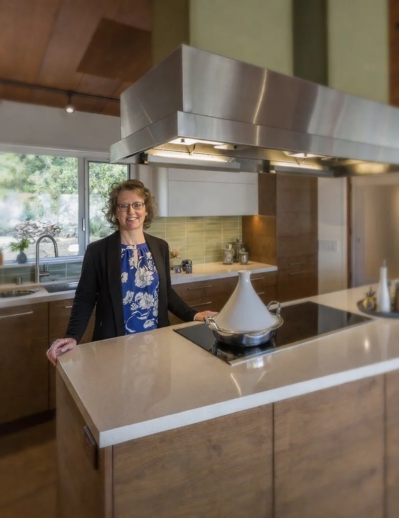Interior designer Jodi Eisner in a warm, mid-century modern California kitchen she designed in Topanga Canyon.