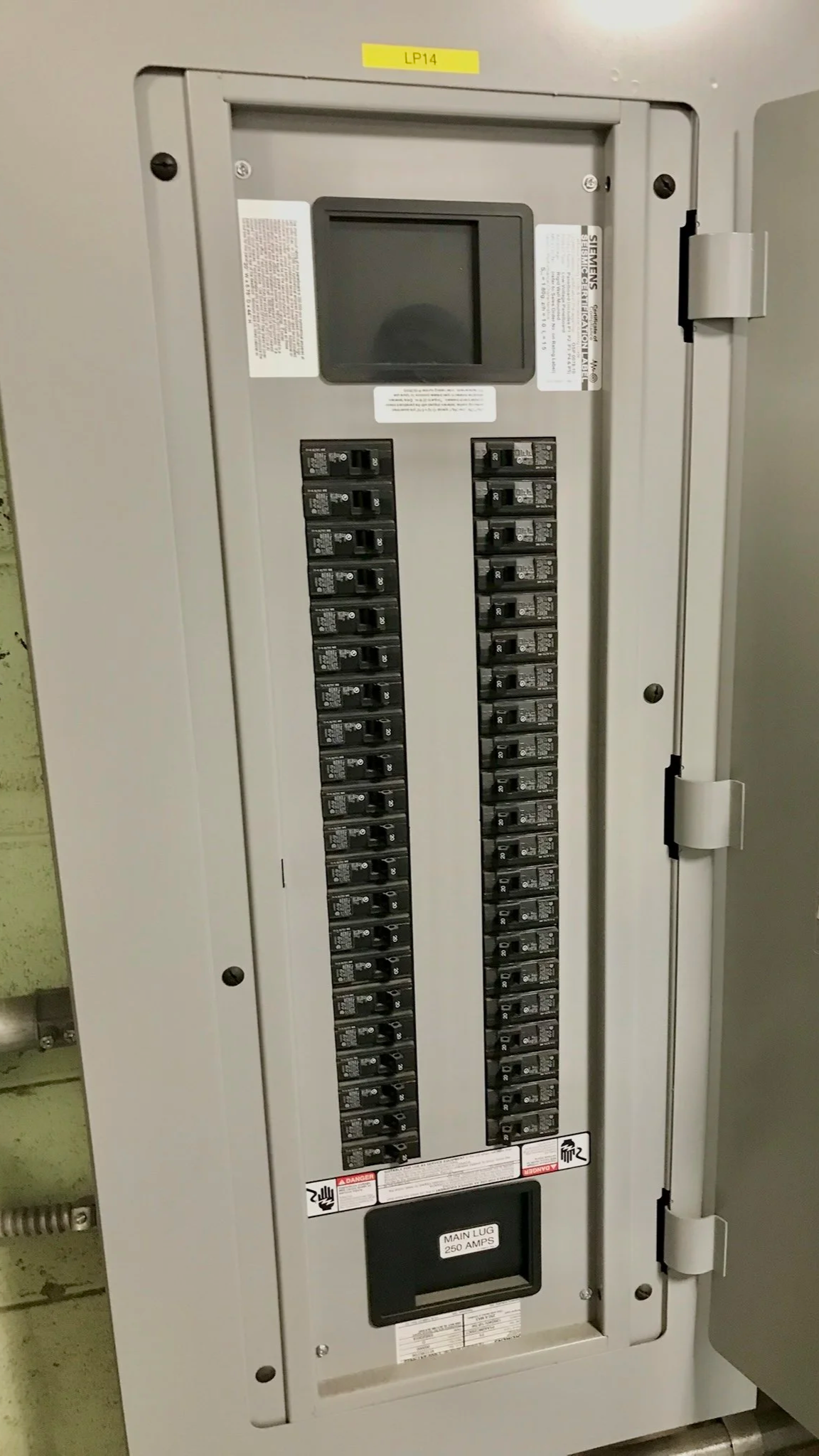An electrical panel with switches and a digital display, labeled with a yellow tag 'LP14' at the top and a label 'MAIN LUG 250 AMPS' at the bottom.