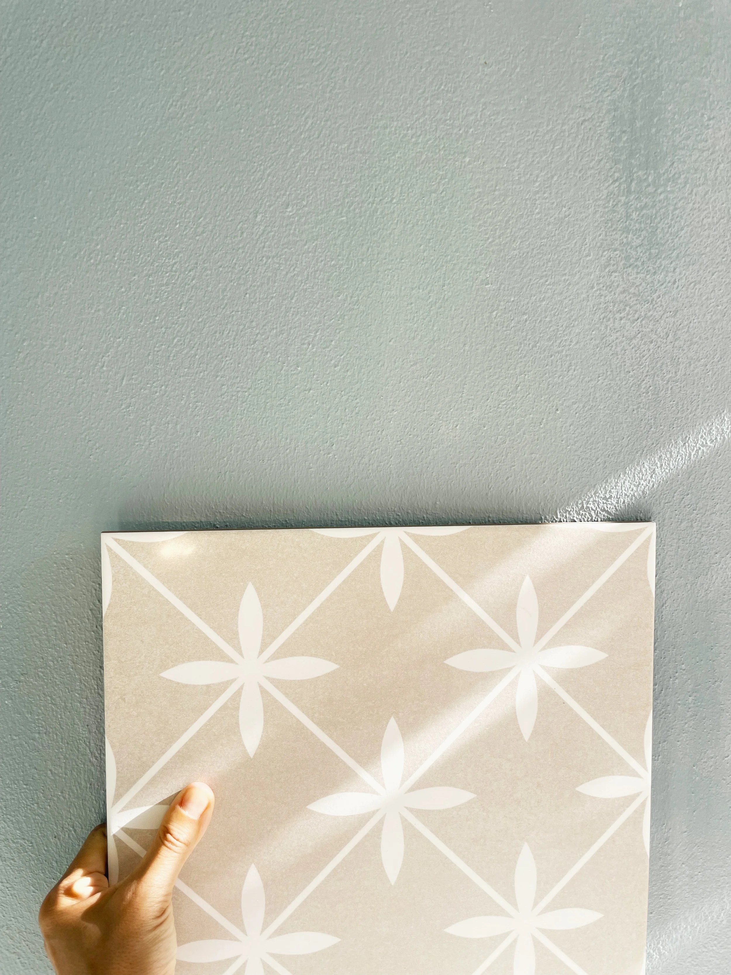 Hand holding tile selection detail interior finish