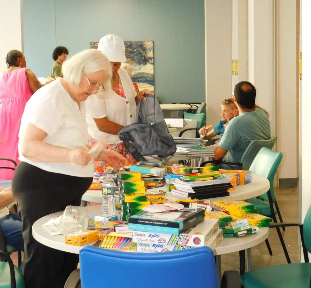 Volunteers and members work together to sort and pack school supplies to provide parents budget savings and their children a strong start for the school year 