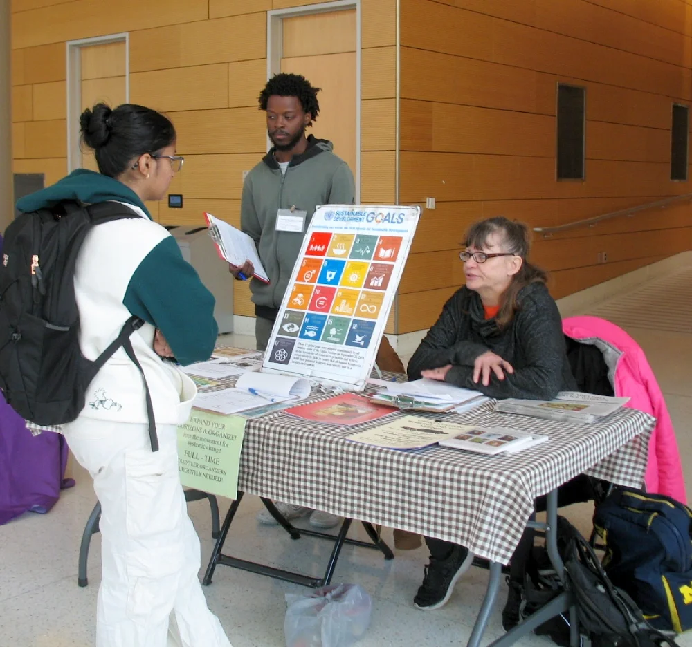 ESWA volunteers man a table promoting the Sustainable Development Goals