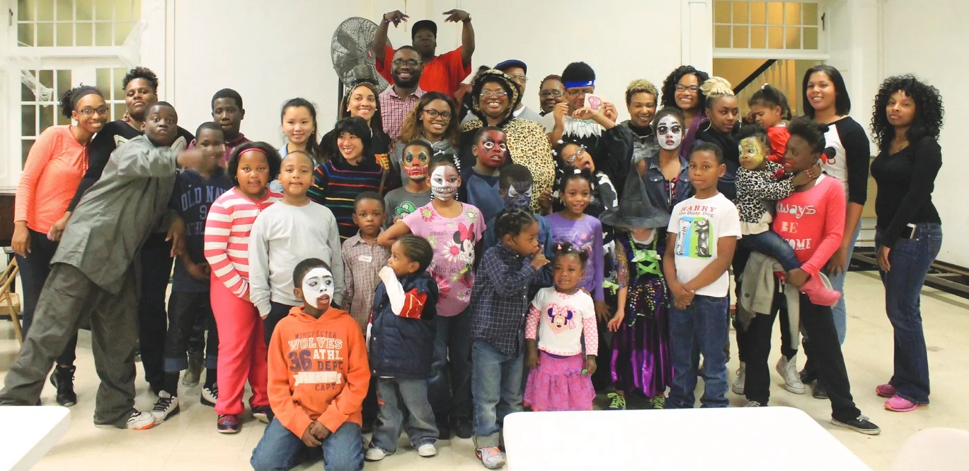 A crowd of 30 children and parents enjoying the annual membership Safe and Sane Halloween Party 