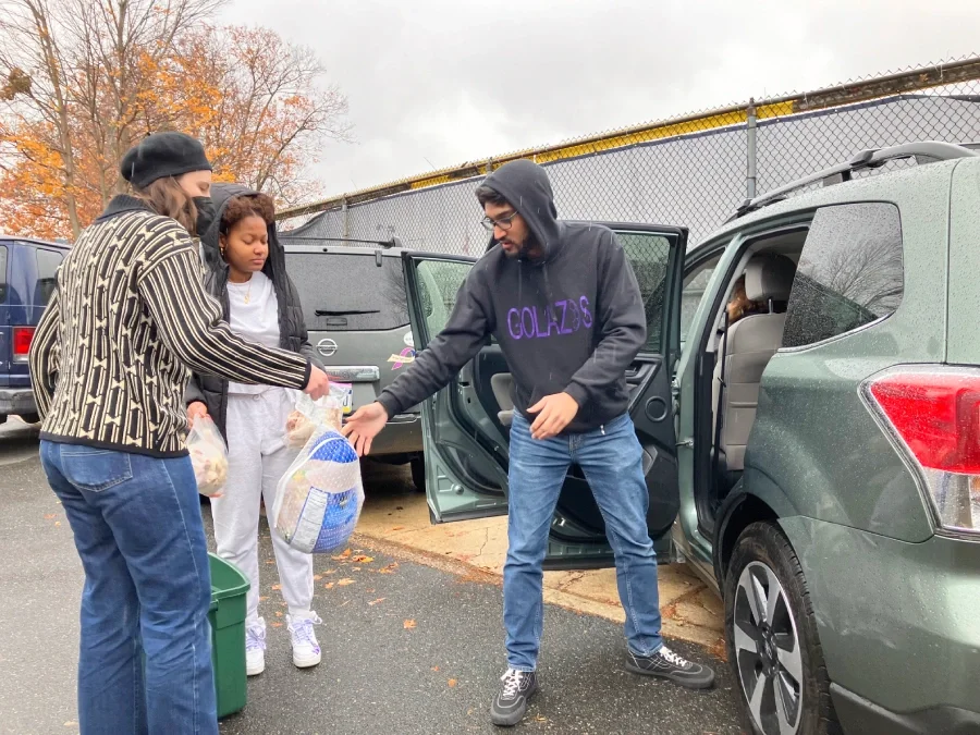 An ESWA volunteer delivering a Thanksgiving food benefit to a member
