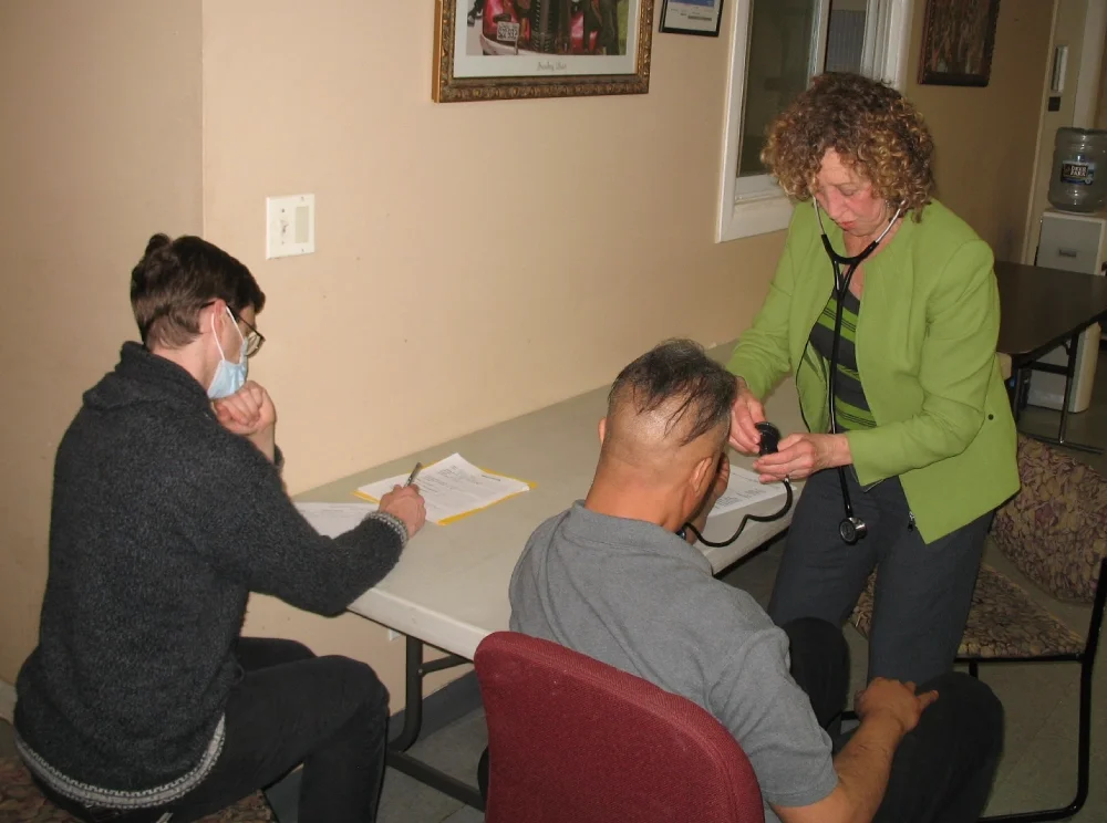 A volunteer doctor sees members free of charge to provide preventive care