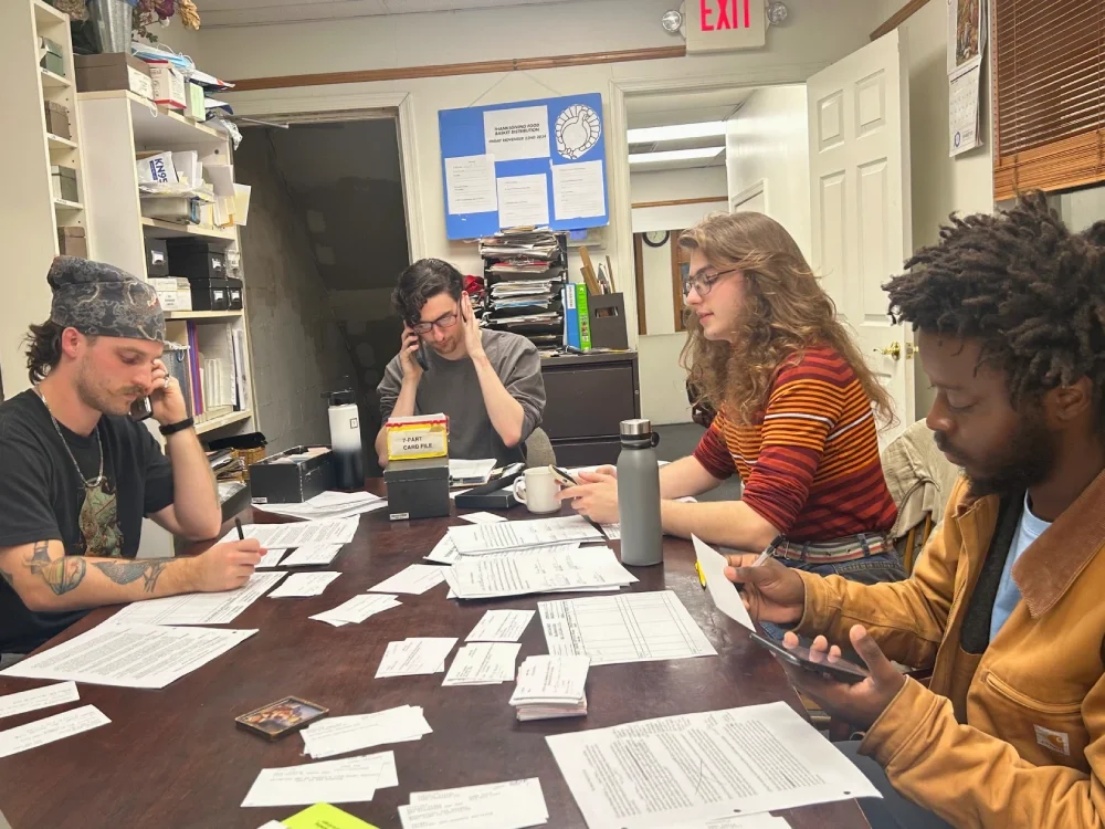 A phone training session teaches volunteers phone skills to schedule new contacts who have signed up tp participate