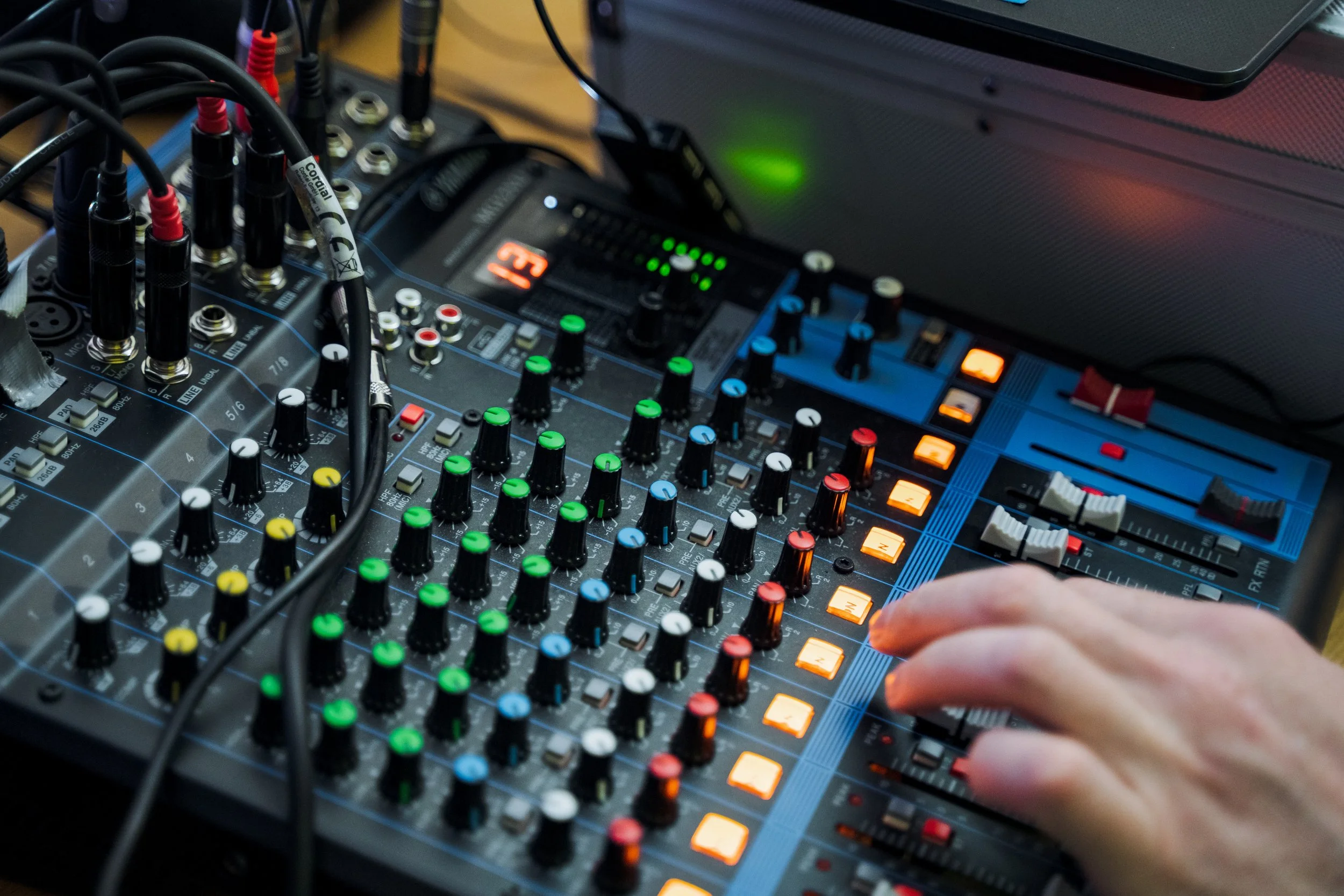 vecteezy_hand-pressing-button-on-mixer-audio-equipment-in-use_54865277.jpg