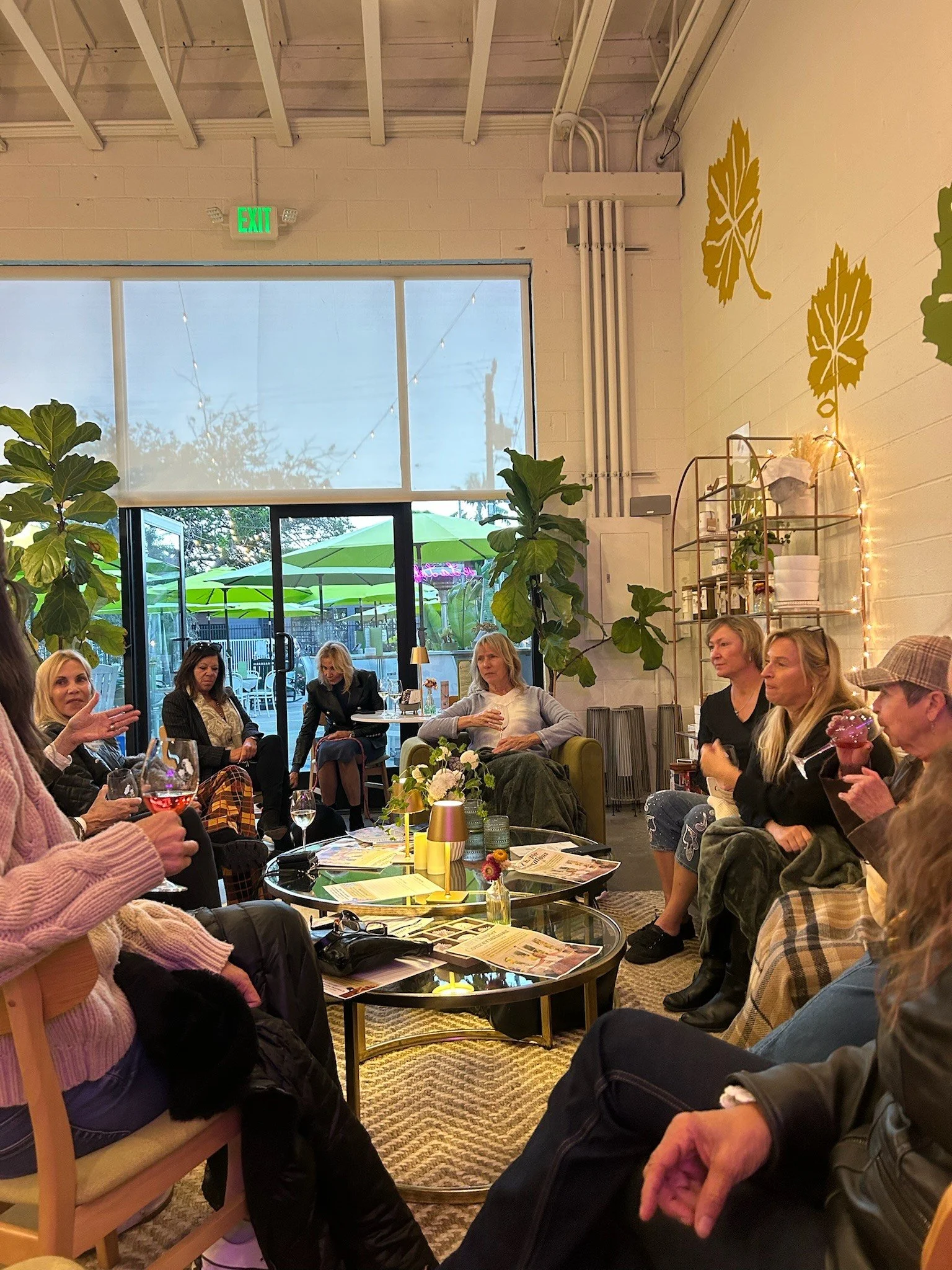 A group of people sitting in the La Lieff tasting room enjoying an event with wine.