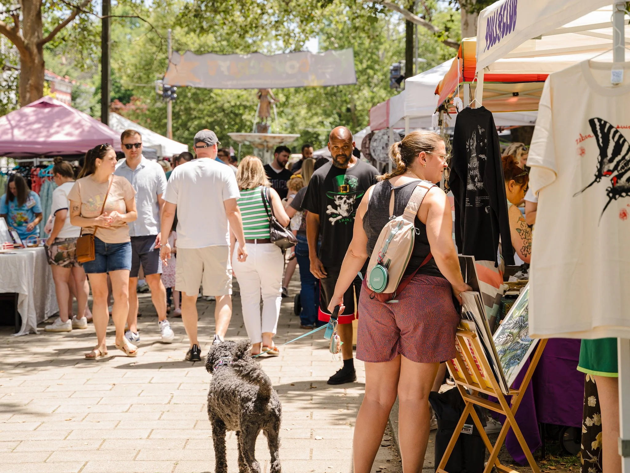 people browsing cov craft outdoor market with goose girl fountain in the background covington kentucky