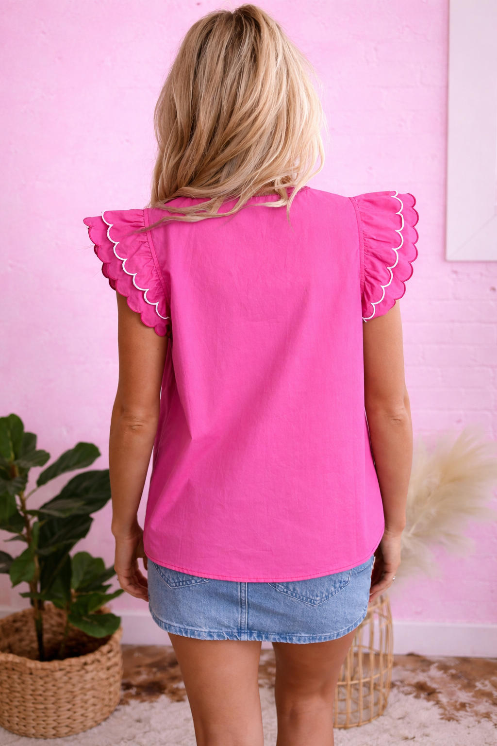 Blonde woman in pink top indoors.png