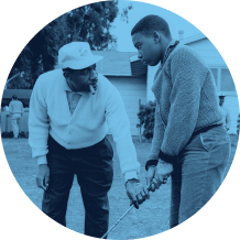 Charlie Sifford helping young golfer