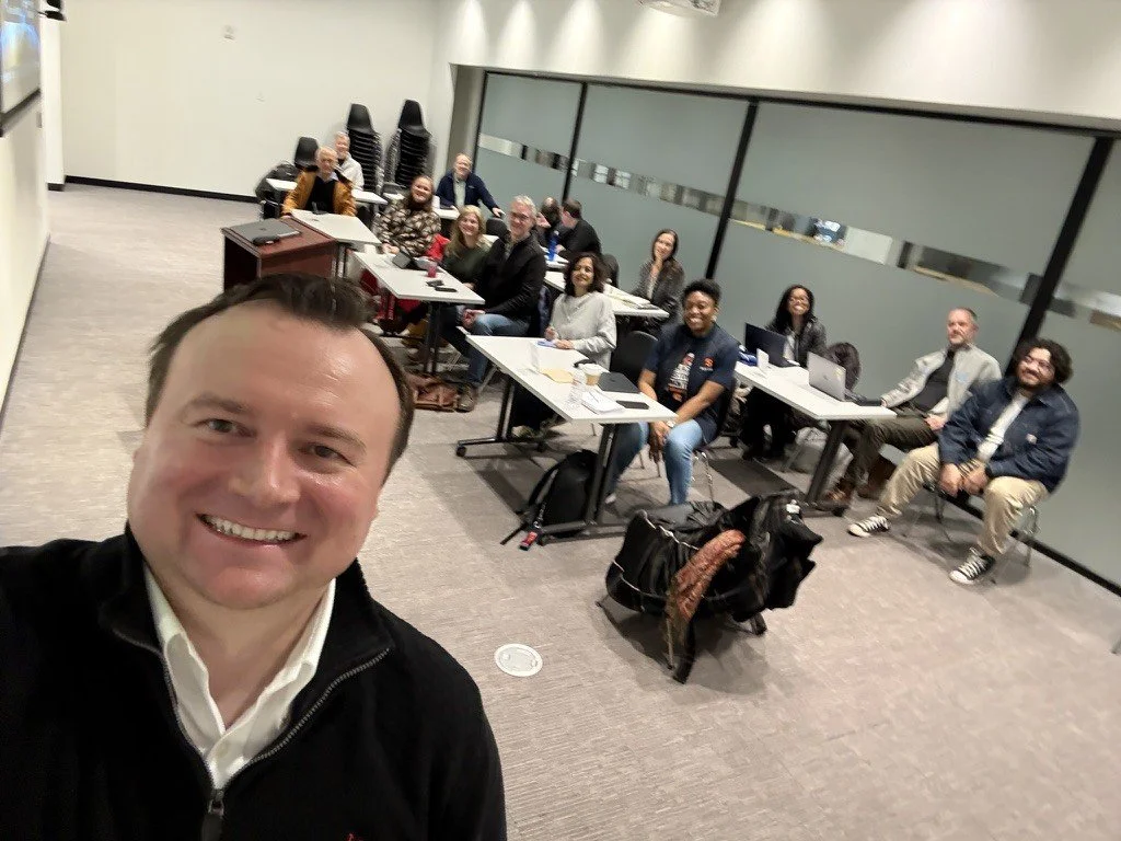 Lecturer and group of students in the background