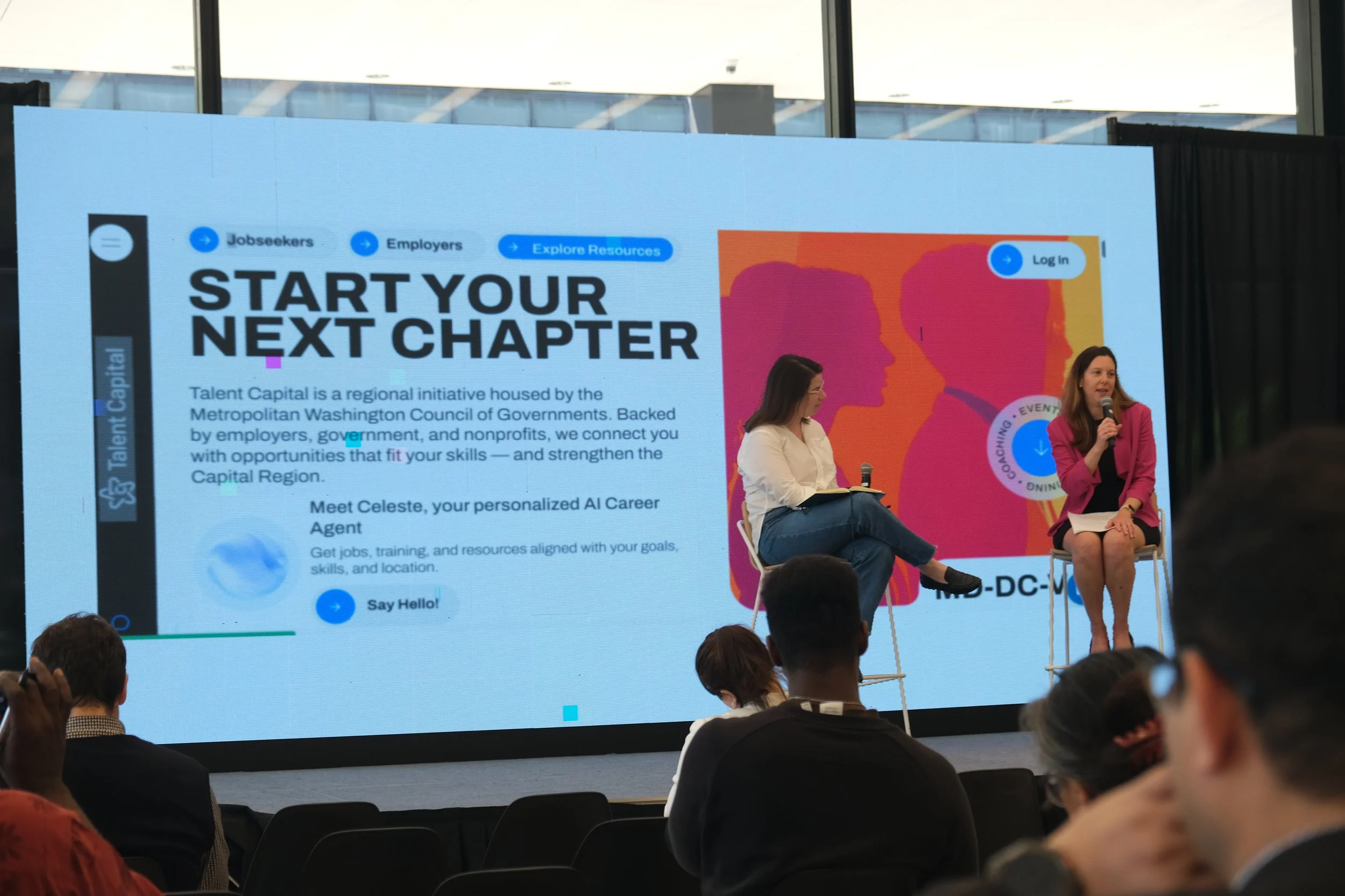 Clara Haskell Botstein speaking to the audience with microphone in hand while Ann Marie Guzzi sits to the left of her on stage. The slide in the background explains DC's TalentCapital.ai initiative.