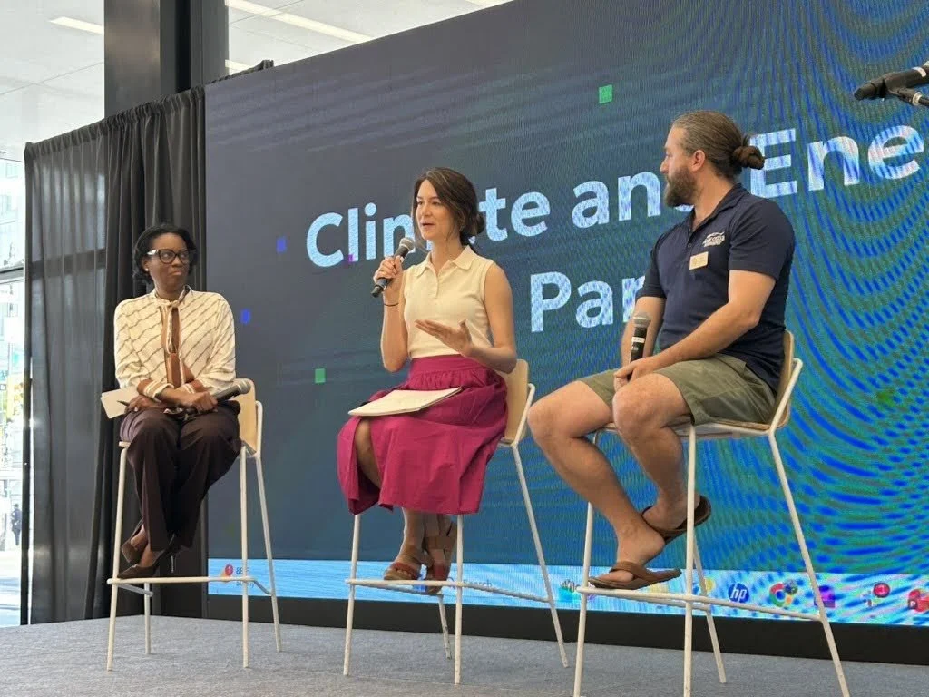 Moderator Rhea L. Marshall with panelists Amanda Bradshaw and Trey Sherard on stage discussing climate and energy issues with AI.