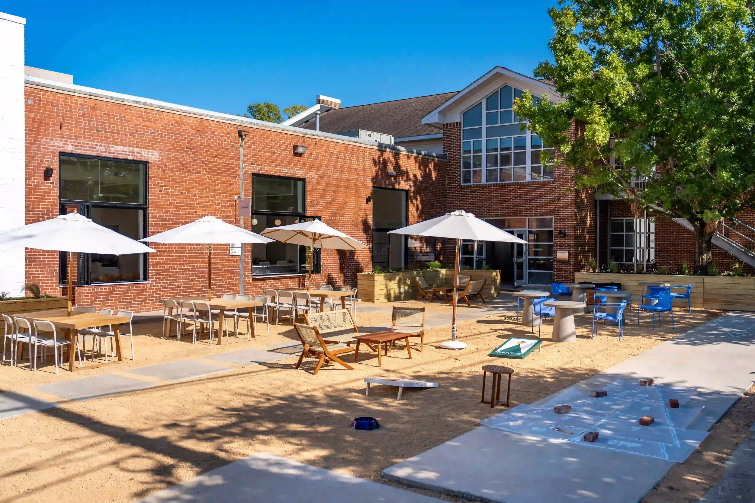Outside view of The Patio outdoor games, including shuffle board and corn hole