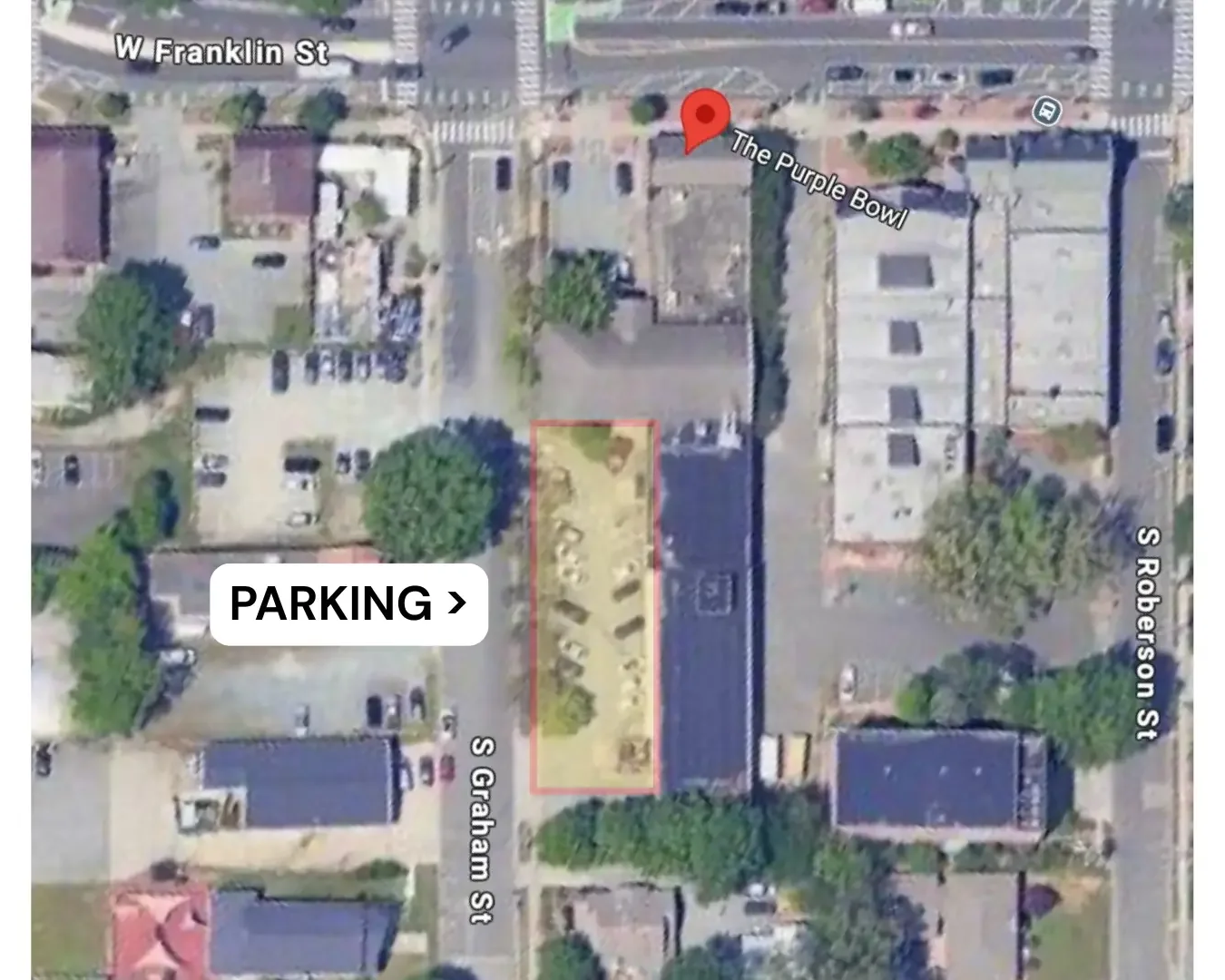 Satellite view of The Purple Bowl showing its parking lot highlighted for directions, with nearby buildings streets labeled W Franklin Street, S Roberson Street, and S Graham Street. The marked parking area is off S Graham Street.