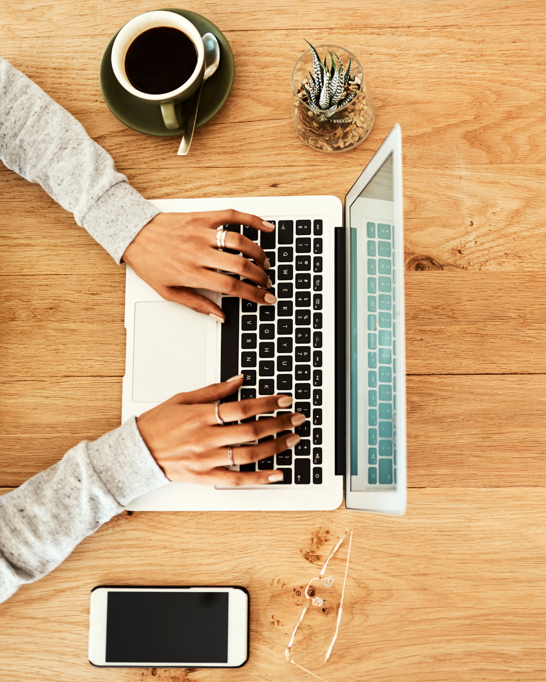 Typing on computer at desk