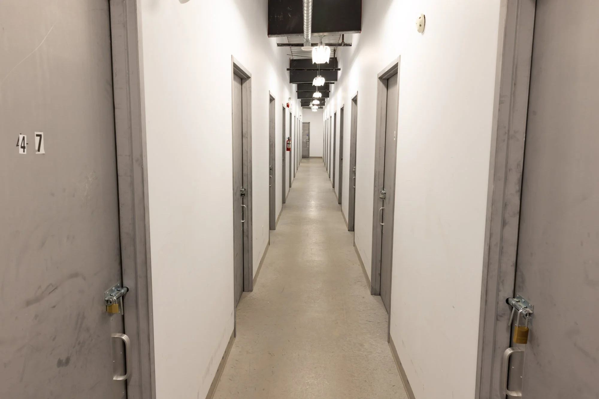 A hallway of secure, indoor, heated storage units in Available Storage facility located in the South End of Sudbury Ontario.