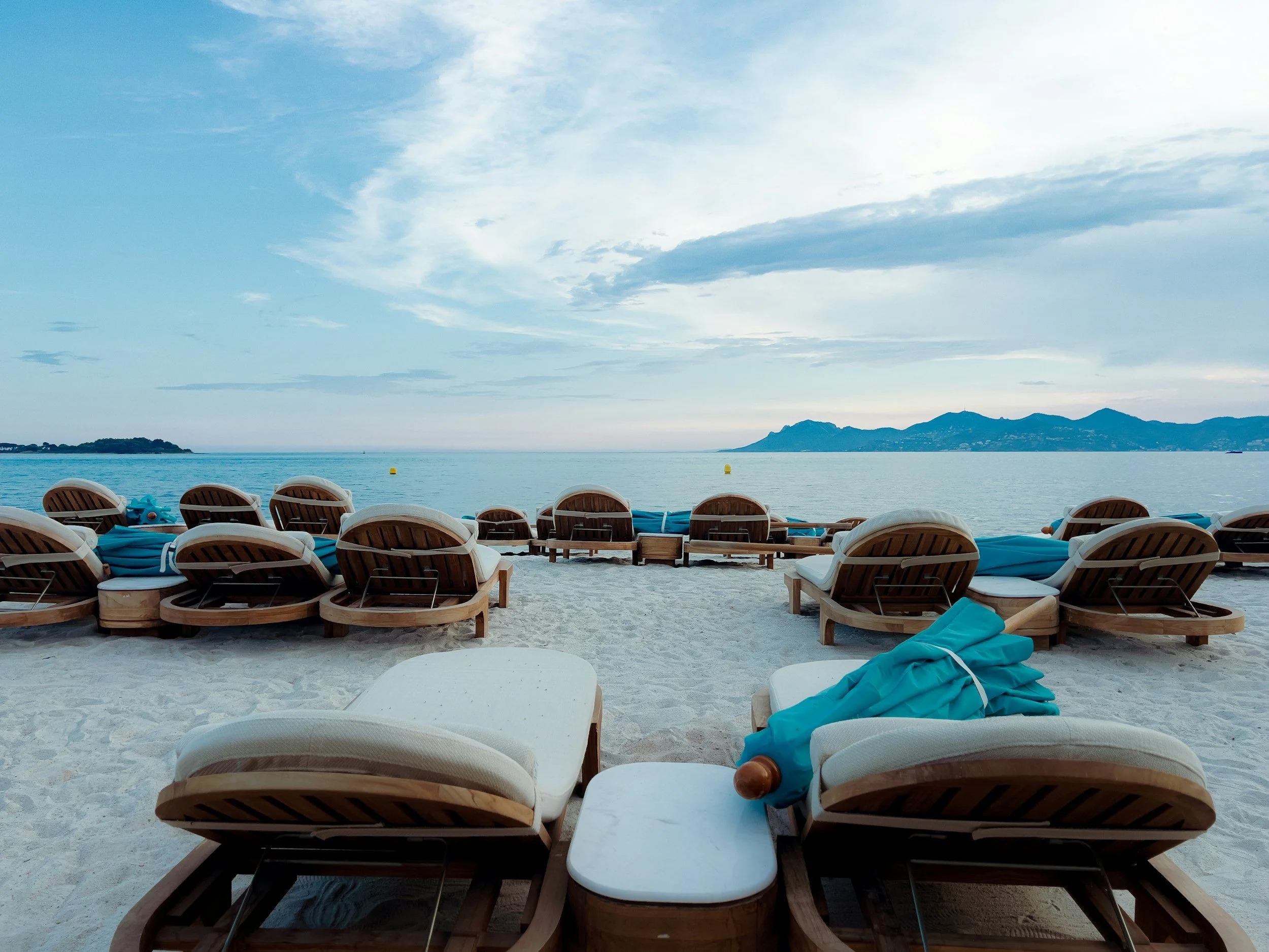 Beachfront loungers in Cabo San Lucas, Mexico facing the ocean—luxury beach resort getaway.