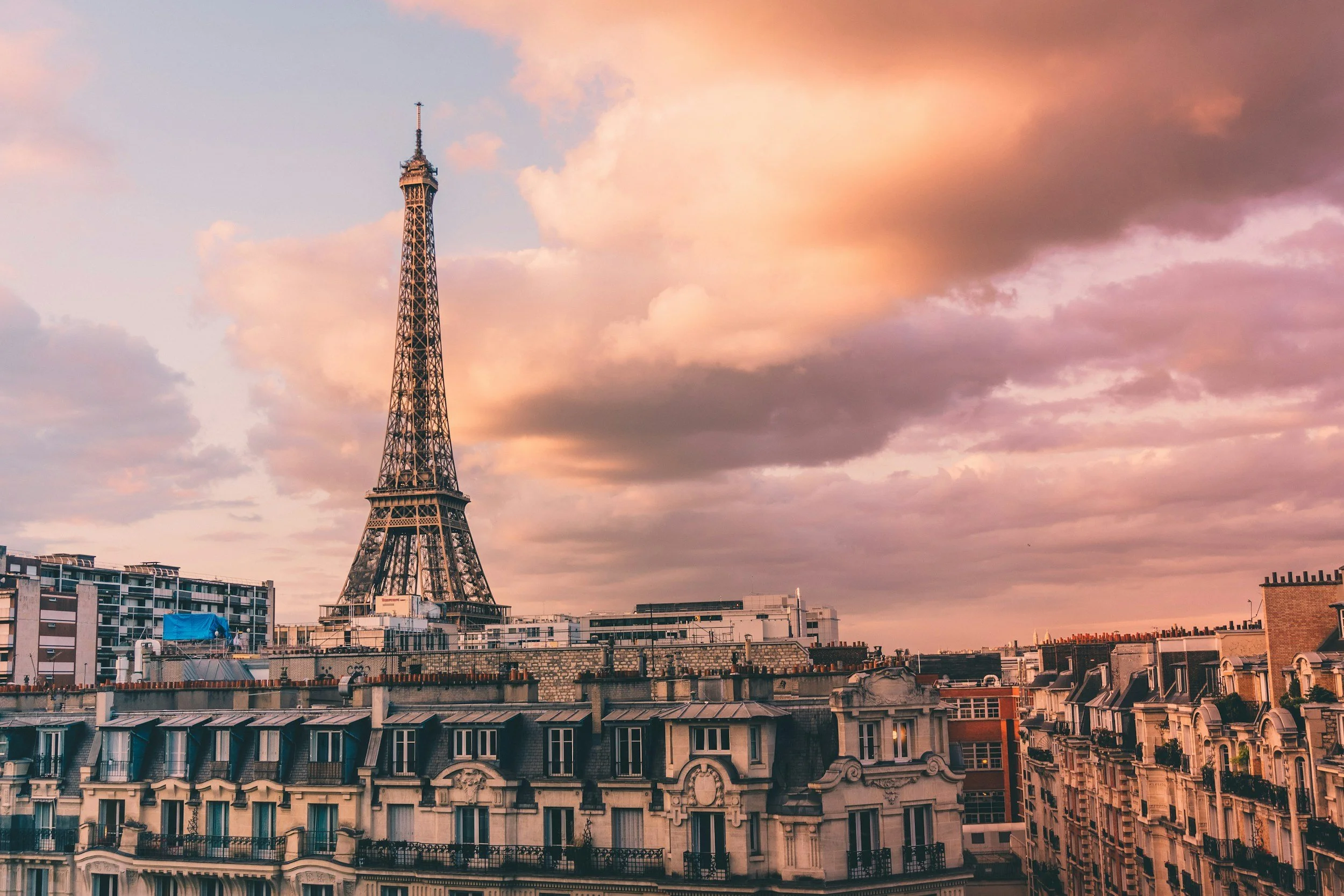 Eiffel Tower at sunset in Paris, France with colorful sky—romantic European honeymoon destination.