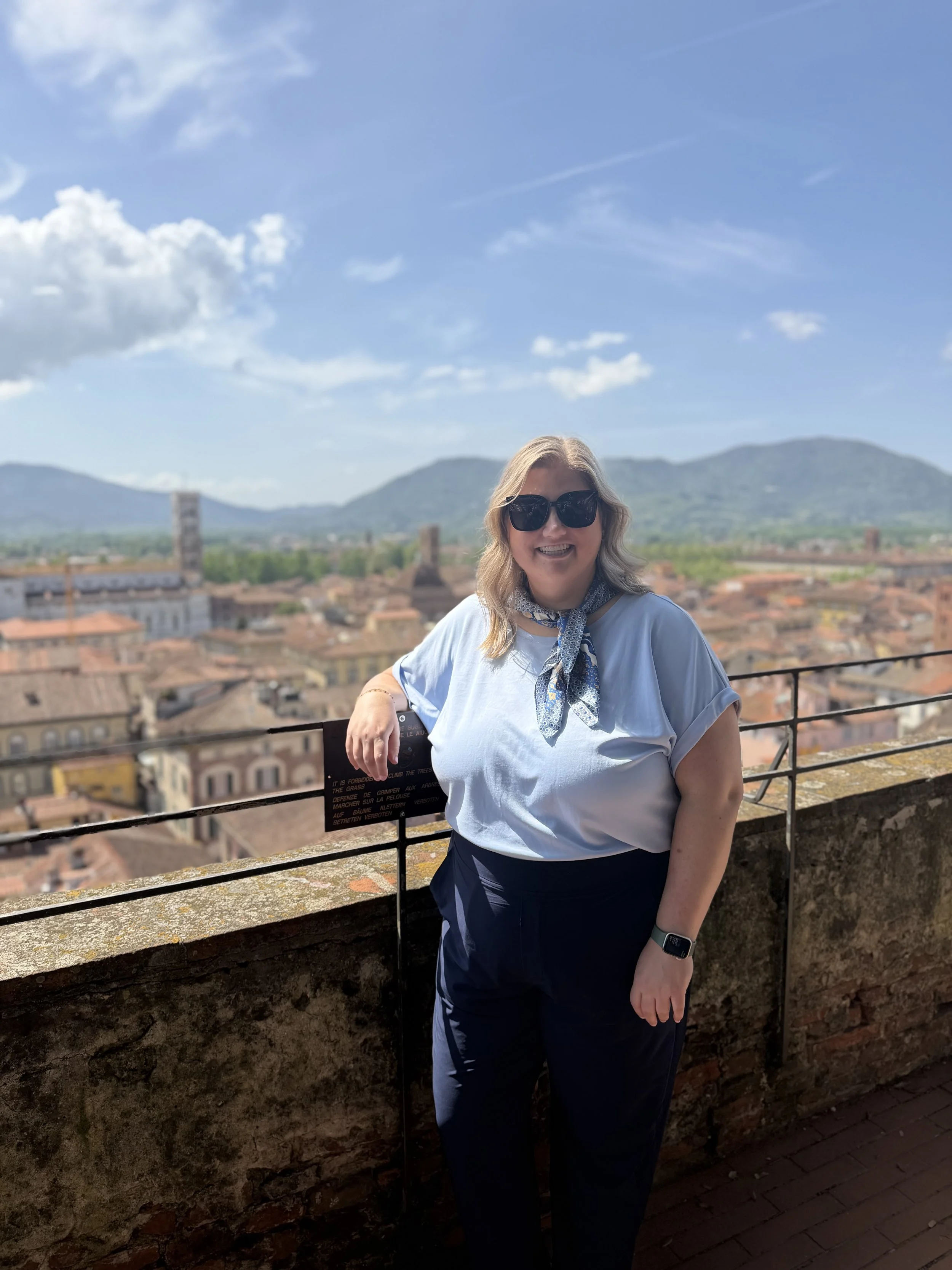 Luxury travel advisor overlooking Lucca, Italy with historic rooftops and countryside views—curated European travel experiences.