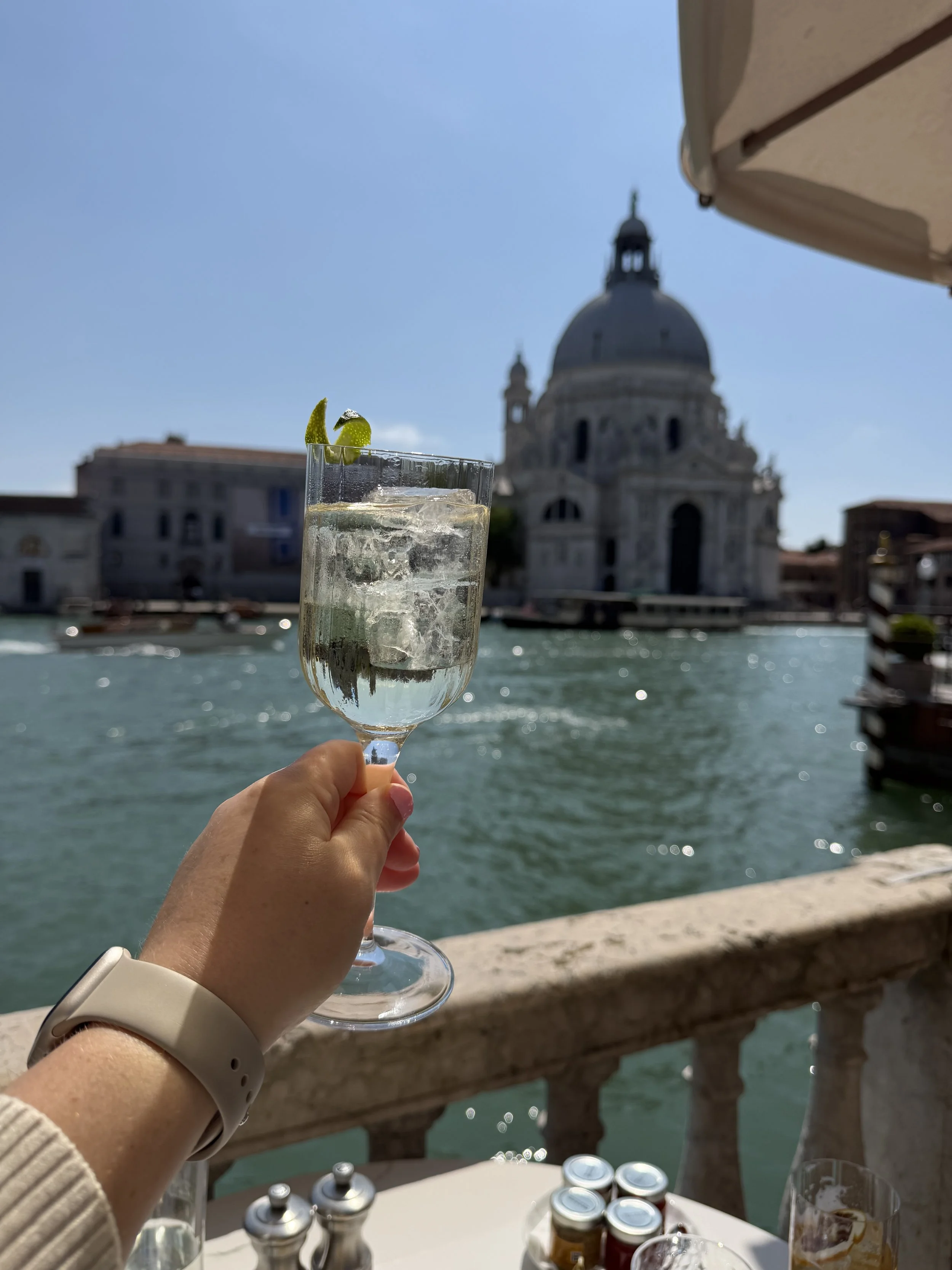 Aperitivo in Venice, Italy overlooking a canal and historic architecture—romantic luxury travel experience.