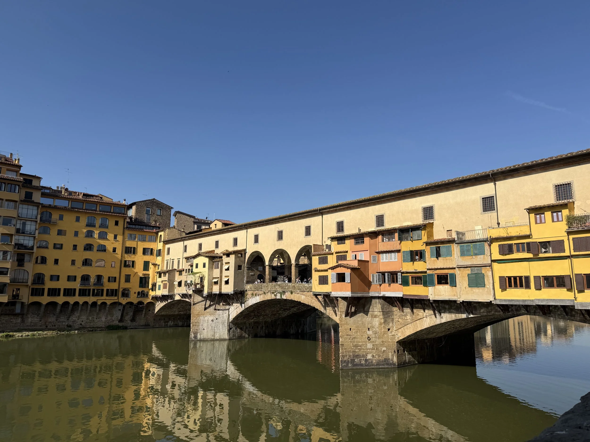 Ponte Vecchio in Florence, Italy with colorful buildings over the Arno River—iconic European travel destination.