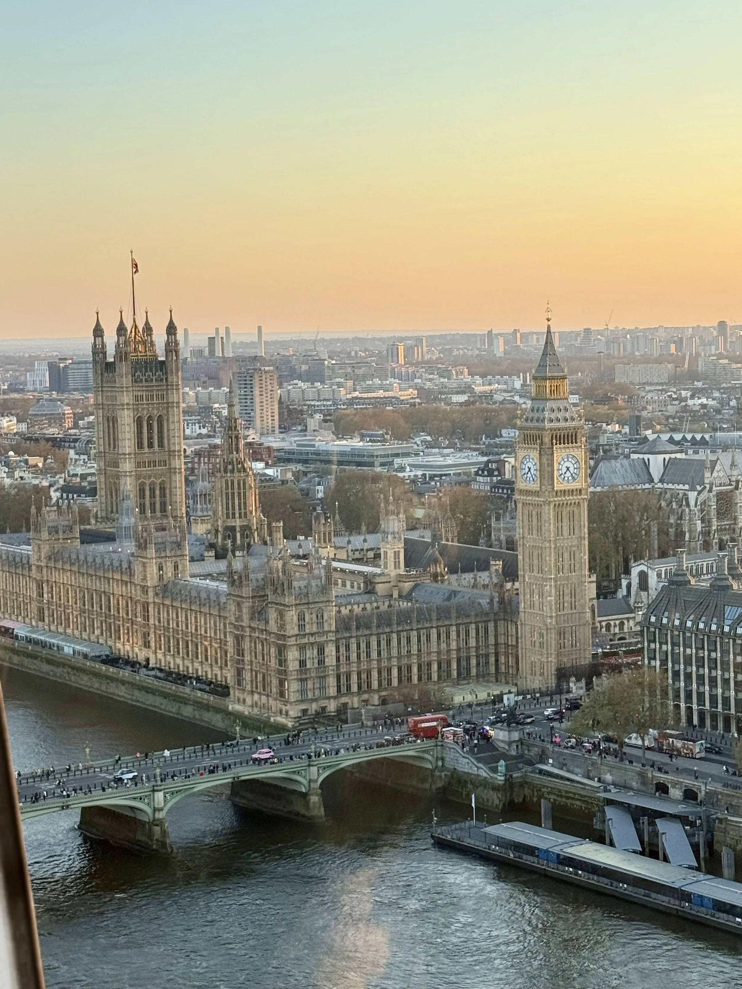 Sunset view of Big Ben and the Houses of Parliament in London along the River Thames—iconic European city travel.