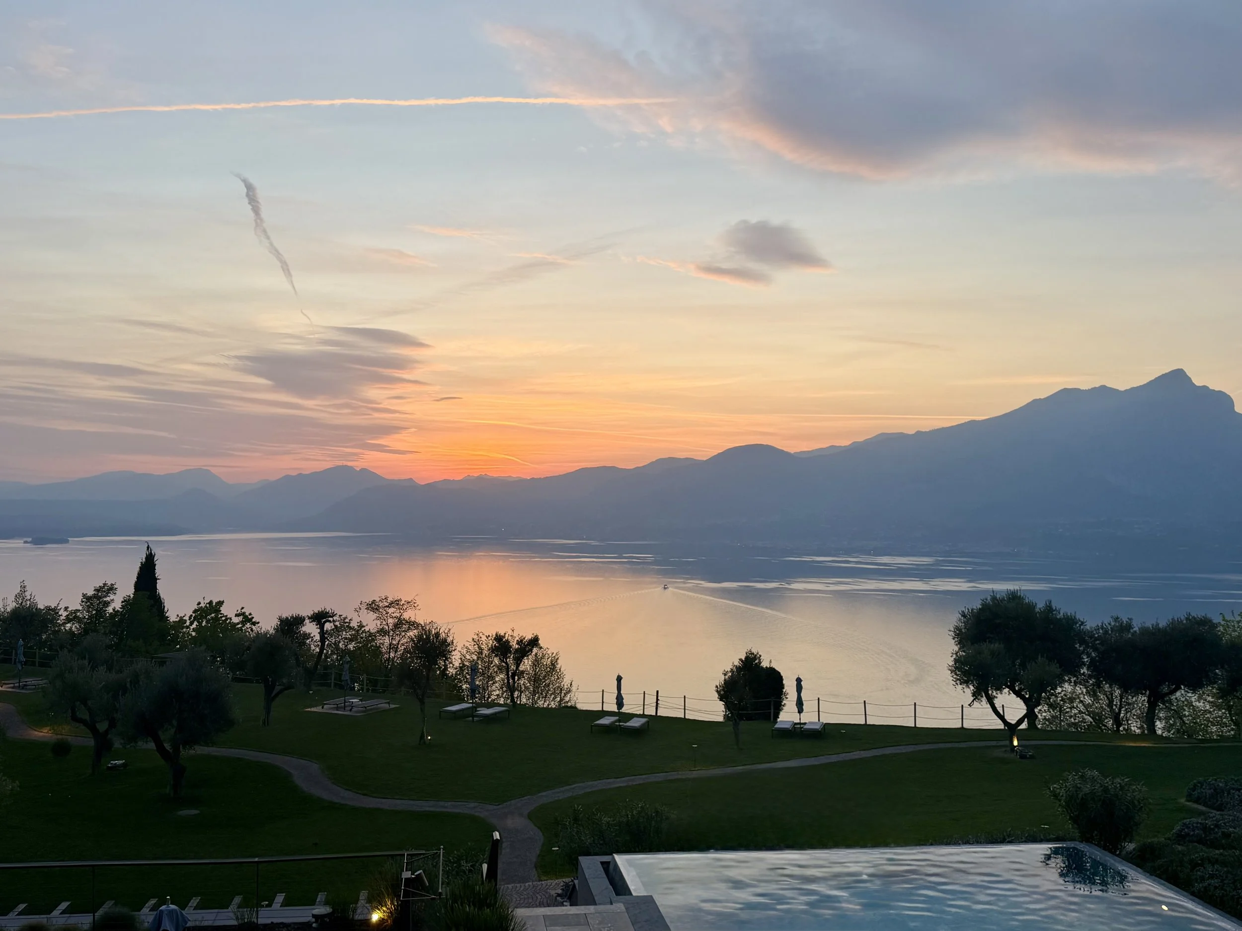 Sunset over Lake Garda, Italy with mountain views—romantic Northern Italy travel destination.